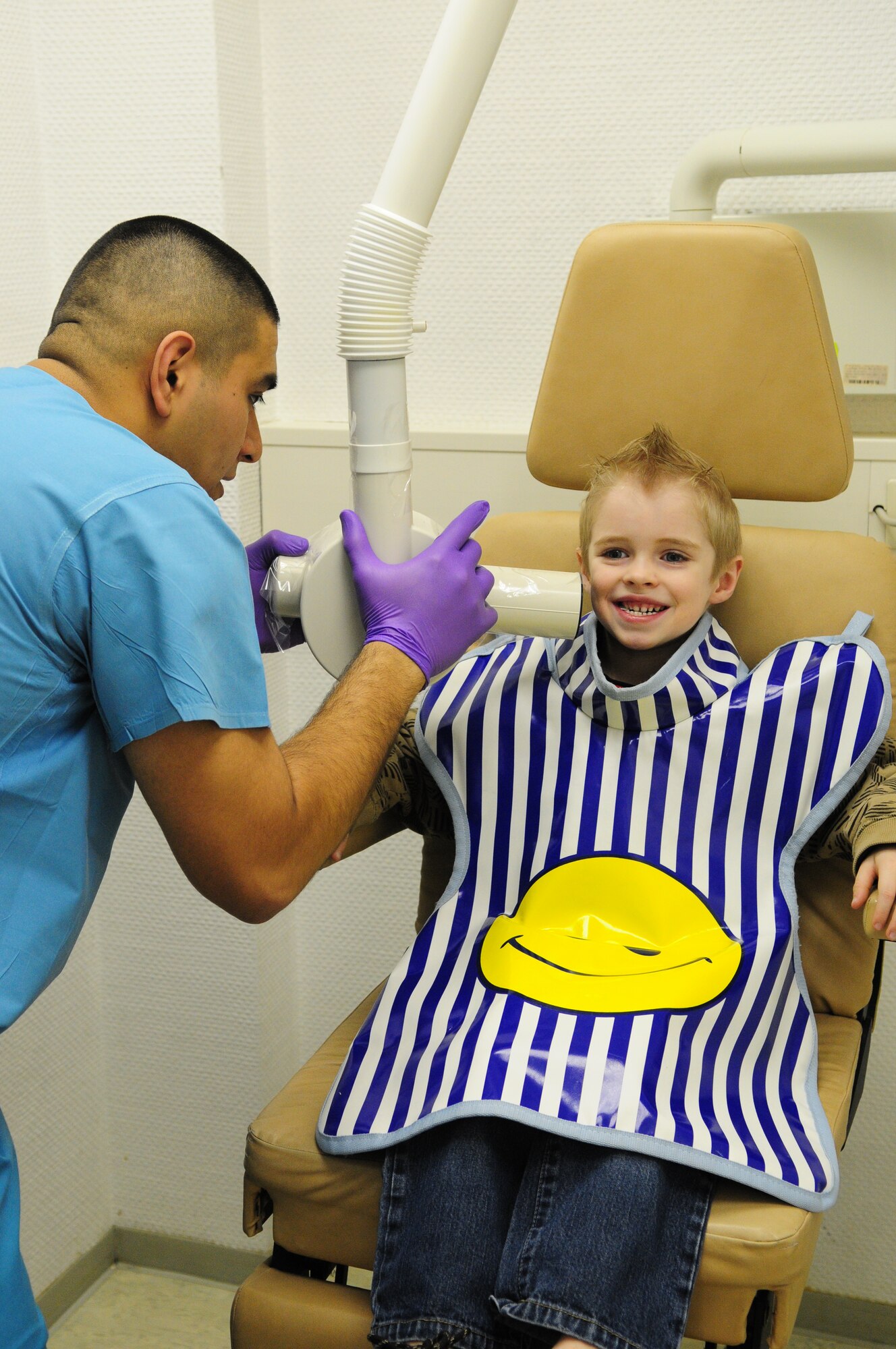 U.S. Air Force Senior Airman Alejandro Juarez, dental assistant journeyman, 86th Dental Squadron, administers an x-ray to Tyler Mechler, 5, son of Tech. Sgt. Brandee Mechler, 24th Intelligence Squadron, Ramstein Air Base, Germany, April 12, 2010. The 86th Dental Squadron serves approximately 200 children and their family in the Kaiserslautern Military Community during their bi-annual event, "Little Teeth Big Smiles". (U.S. Air Force photo by Airman 1st Class Desiree Esposito)