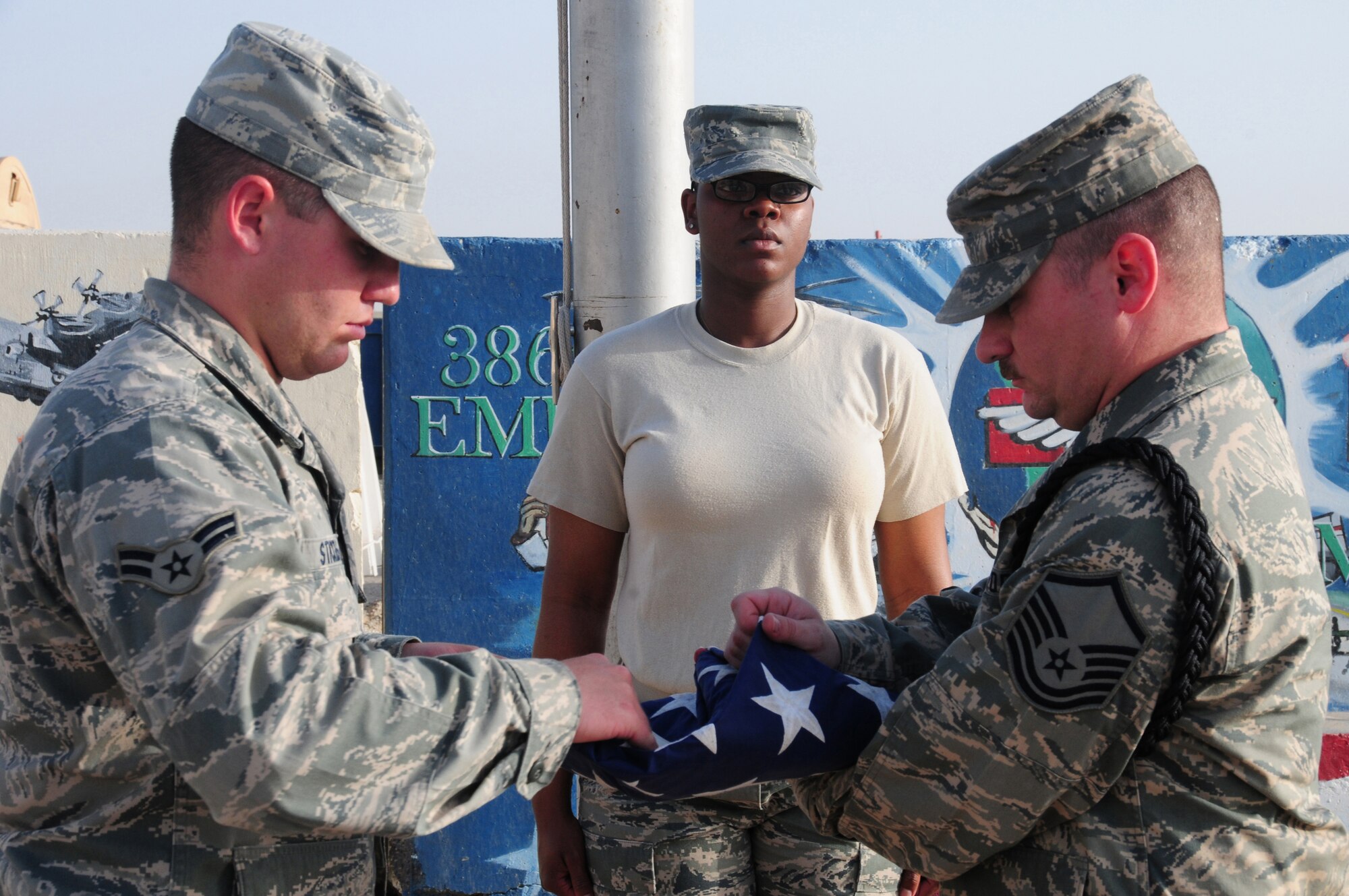 SOUTHWEST ASIA --  From left, 386th Air Expeditionary Wing Honor Guard members U.S. Air Force Airman 1st Class Wesley Stickels, Senior Airman Erica Elam, and Master Sgt. Andrew Bodine rehearse for a "retreat" ceremony during a routine practice here April 6, 2010 at an air base in Southwest Asia. The base honor guard participates in several ceremonies weekly, to include change of command and promotion ceremonies.  (U.S. Air Force photo by Staff Sgt. Lakisha A. Croley/Released)