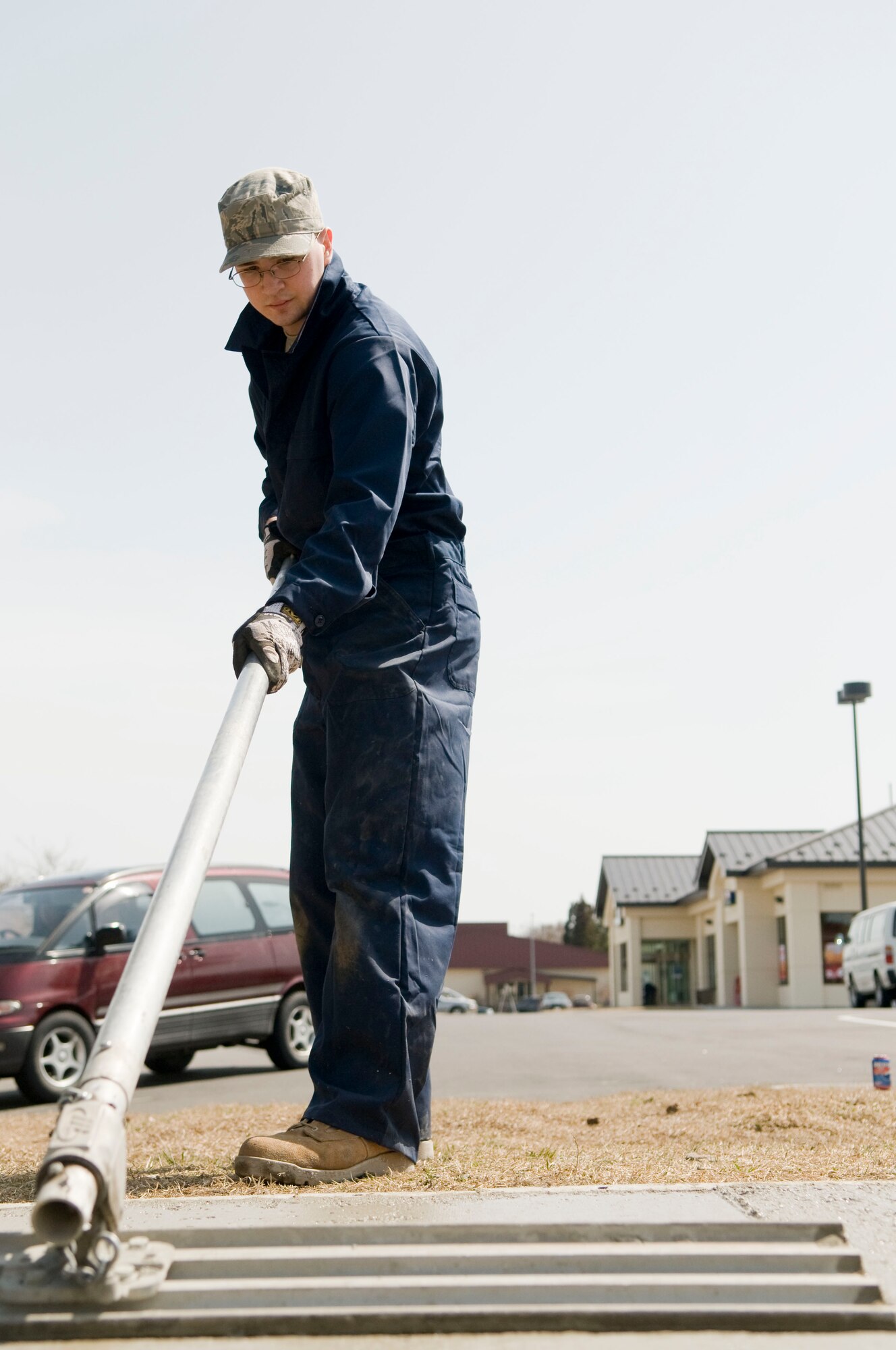 MISAWA AIR BASE, Japan – Airman 1st Class Steven Leary, 35th Civil Engineering Squadron pavement and equipment operator, uses a concrete finishing tool, known as a bull float, to smooth out the surface of a freshly poured sidewalk, April 9 alongside Freedom Drive. Airmen from 35th CES replaced an uneven section of sidewalk, which posed a hazard for Misawa Air Base residents. (U.S. Air Force photo/Senior Airman Jessica Lockoski)

