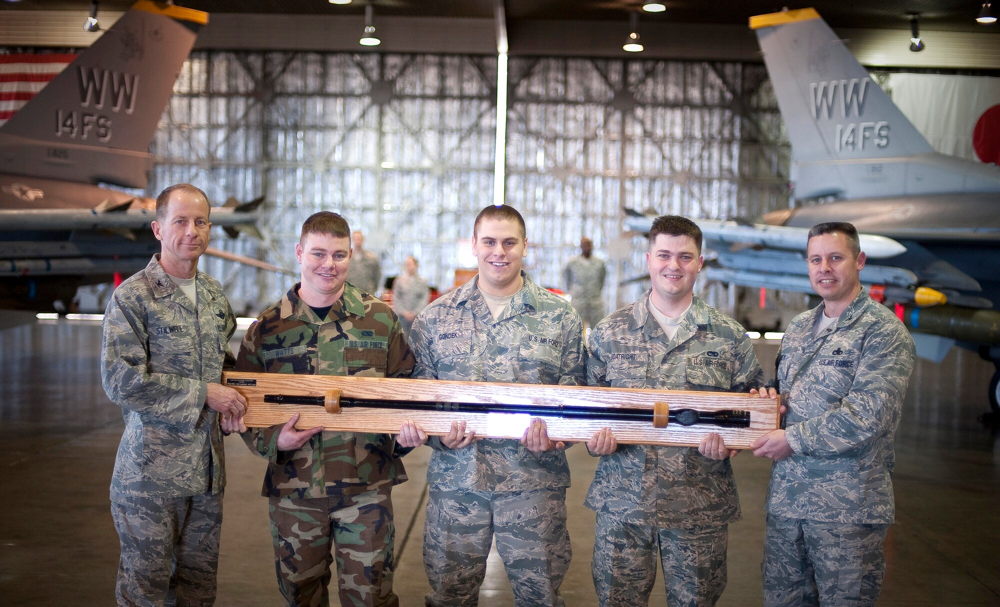 MISAWA AIR BASE, Japan -- Staff Sgt. Zachary Watts, Airman 1st Class David Gondek and Senior Airman Justin Boatright, 14th Aircraft Maintenance Unit load crew members, receive the award for best load crew from Col. David Stilwell, 35th Fighter Wing commander and Col. Kyle Matyi, 35th Maintenance Group commander after a load crew competition Apr. 9. This is the third consecutive win for the 14th AMU. (U.S. Air Force photo/Staff Sgt. Chad C. Strohmeyer)