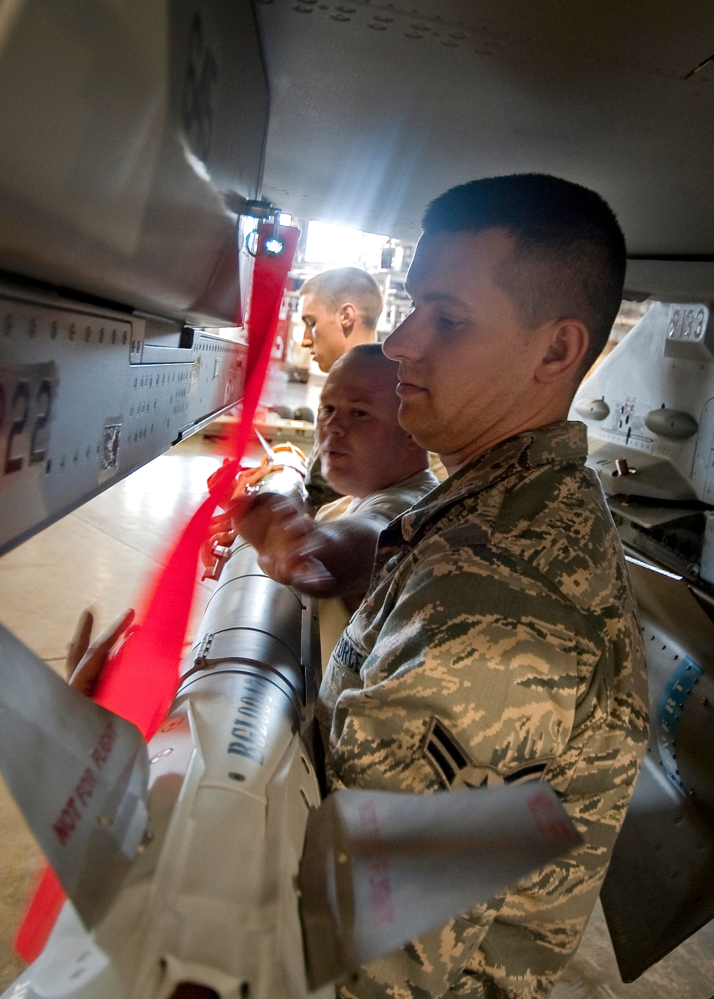 MISAWA AIR BASE, Japan -- Airman 1st Class Benjamin Fisher, Staff Sgt. Christopher Durden and Airman 1st Class Paul Callahan, 13th Aircraft Maintenance Unit load crew members, load an AIM-9X Sidewinder Missile on an F-16 Fighting Falcon during a load crew competition Apr. 9. During the competition, the Airmen are graded on a variety of areas which include, speed, accuracy, appearance and safety. (U.S. Air Force photo/Staff Sgt. Chad C. Strohmeyer)