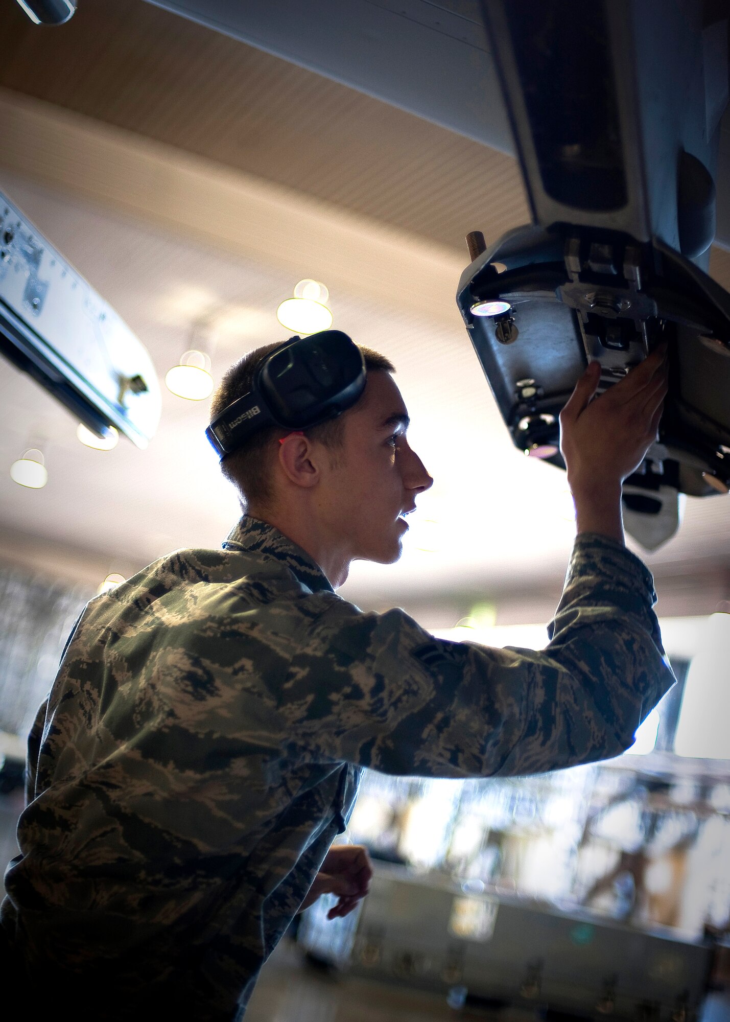 MISAWA AIR BASE, Japan -- Airman 1st Class Paul Callahan, 13th Aircraft Maintenance Unit load crew member, prepares an F-16 Fighting Falcon for munitions during a load crew competition Apr. 9. Load crew competitions increase efficiency and build a sense of camaraderie within the unit. (U.S. Air Force photo/Staff Sgt. Chad C. Strohmeyer)