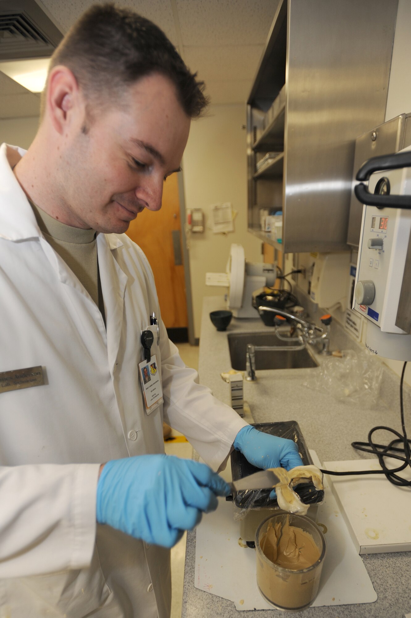 WHITEMAN AIR FORCE BASE, Mo. - Staff Sgt. James Anderson, 509th Medical Operation Squadron dental lab technician, vibrates the clay-like mixture into the molds to create a positive cast of the patients teeth to mold a night guard, April 9, 2010. The cast will set up and then be placed with the other half to mimic the jaw of the patient. (U.S. Air Force photo/ Airman 1st Class Carlin Leslie) (Released) 
