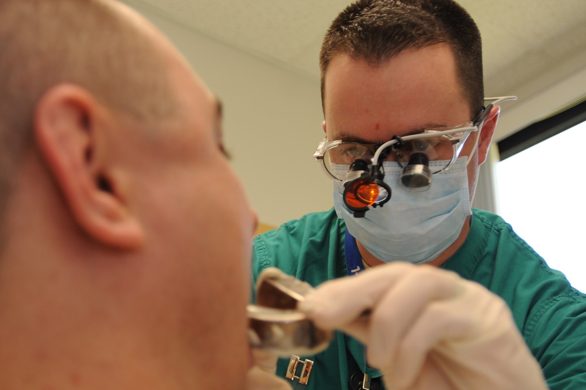 WHITEMAN AIR FORCE BASE, Mo. - Capt. Carl Bhend, 509th Medical Operation Squadron dentist, inserts the lower plate into the patients mouth for molding of a night guard, April 9, 2010. After Captain Bhend takes the impressions of the top and bottom of the patient's teeth, the impressions will be taken to the lab technicians to create the guard.(U.S. Air Force photo/ Airman 1st Class Carlin Leslie) (Released)
