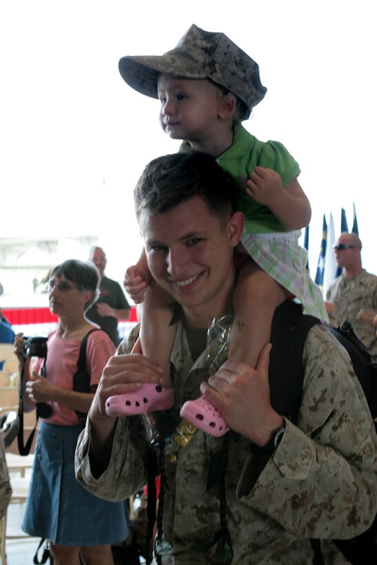 U.S. Marine Corps Staff Sgt. Nick Green holds his son on his shoulders on Marine Corps Air Station Kaneohe Bay, Hawaii, March 12, 2010. Green, assigned to the Marine Heavy Helicopter Squadron 463, is returning from a seven-month deployment to Afghanistan.