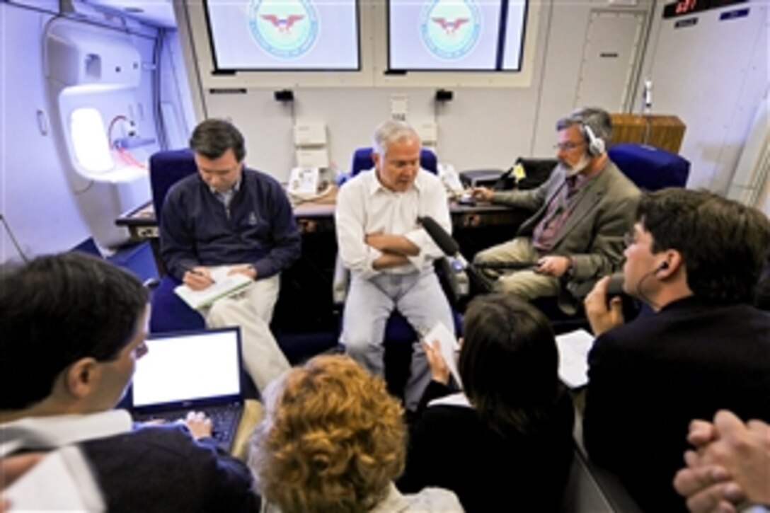 U.S. Defense Secretary Robert M. Gates talks with members of the press while onboard a U.S. Air Force aircraft en route to Lima, Peru, as part of a four-day trip to South America, April 13, 2010.