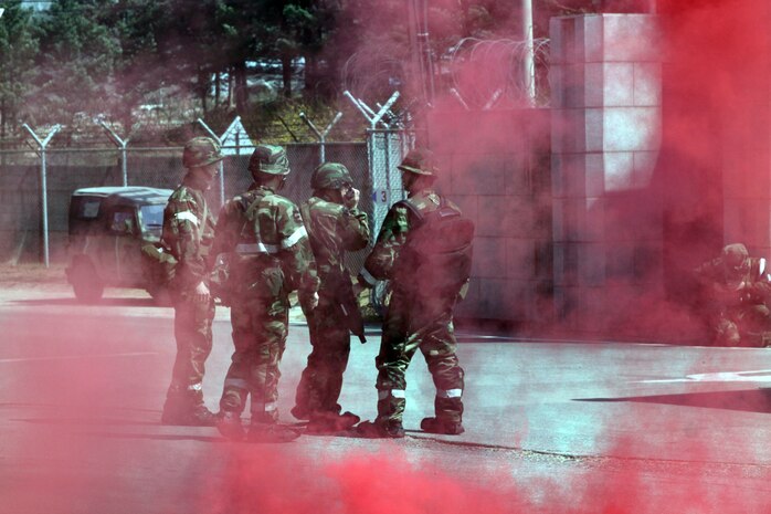 Yechon Air Base, REPUBLIC OF KOREA - Republic of Korea Air Force military police work to secure the area after a simulated improvised explosive device detonated  during a training exercise here April 13 as part of Exercise Foal Eagle 2010. The ROK military police worked hand-in-hand with the Marines to secure the area.