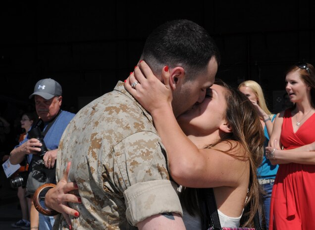 Lance Cpl. David Checrallah hugs and kisses his wife Christina in front of the Marine Attack Squadron 513 hangar at the Marine Corps Air Station in Yuma, Ariz., April 13, 2010. Approximately 100 VMA-513 Marines deployed with the 11th Marine Expeditionary Unit for a seven-month deployment touring the Middle East and Horn of Africa. While on deployment the squadron participated in eight exercises with other nations providing close-air support and escorting helicopters for a majority of the exercises.