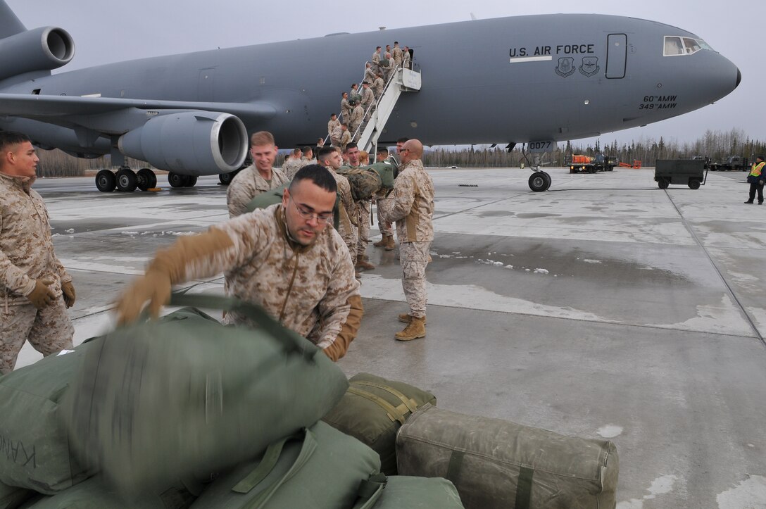 Marines with Marine Attack Squadron 211 unload their gear from a KC-10 on the flight line of Eielson Air Force Base in Alaska after a seven-hour flight from Yuma April 13, 2010. More than 160 Marines from VMA-211 and Marine Aviation Logistics Squadron 13 flew north to participate in Exercise Red Flag-Alaska, one of the largest joint-service exercises in the U.S. military. The Avengers’ eight AV-8B Harriers comprise part of the 100 aircraft participating in the exercise.