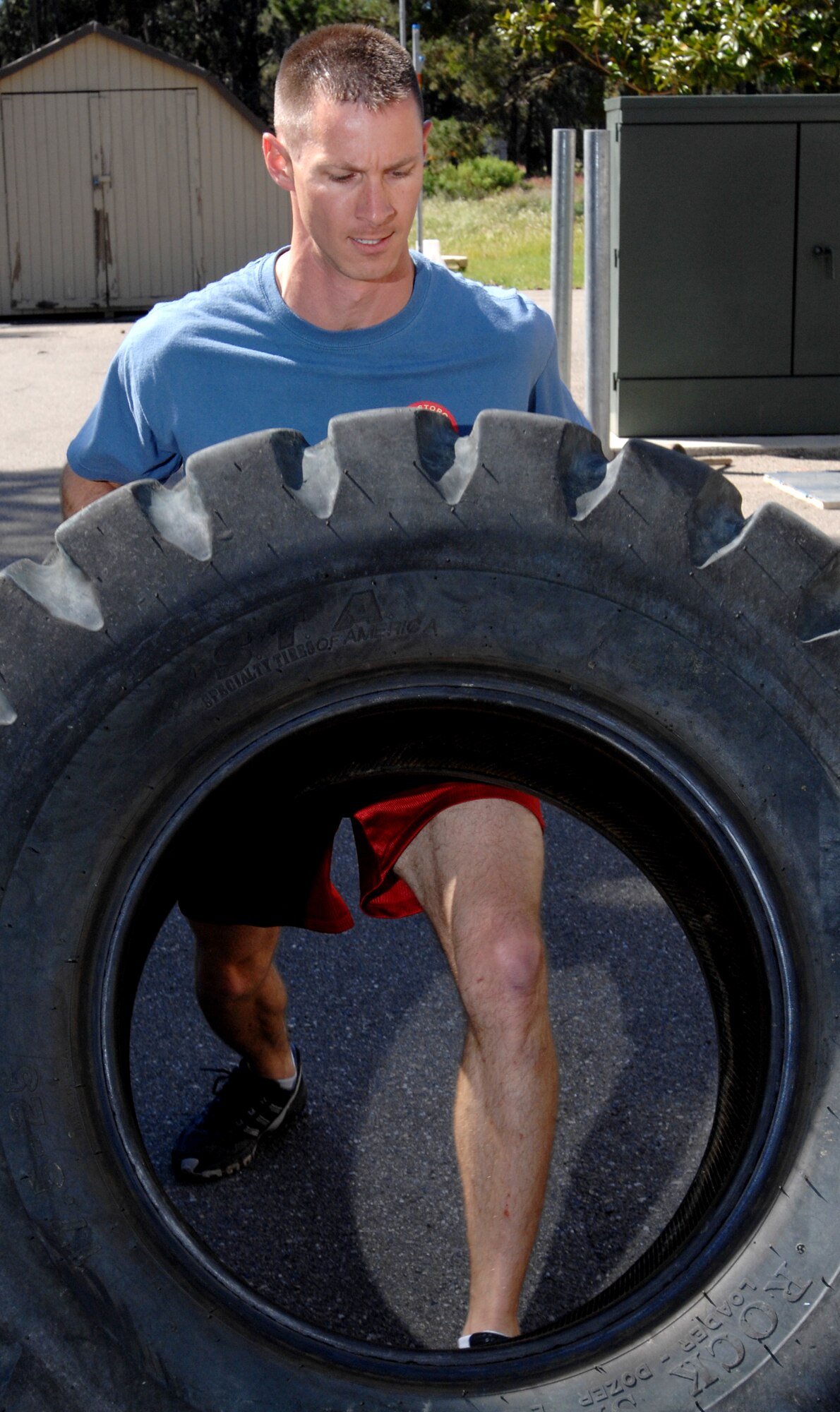 VANDENBERG AIR FORCE BASE, Calif. -Staff Sgt. Domonic Buzzelli, of the 30th Security Forces Squadron, flips a tire during training for Guardian Challenge at the old base gym here Tuesday, April 13, 2010. Team exercises include resistance runs, tire flips, box jumps, and rope climbs. (U.S. Air Force photo/Senior Airman Christopher Hubenthal)