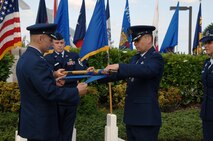 Col. Charles Baumgardner, 15th Mission Support Group commander (left), and Lt. Col. Timothy Telega, former 15th Services Squadron commander, retire the 15 SVS guidon at the 15th Force Support Squadron Assumption of Command ceremony here April 14. During the ceremony, the 15th Mission Support Squadron and the 15 SVS were deactivated and then re-activated jointly as the 15 FSS. (U.S. Air Force photo by Senior Airman Nathan Allen)