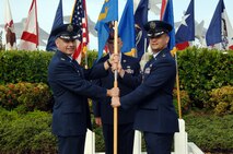 Col. Charles Baumgardner, 15th Mission Support Group commander (left), takes the 15th Services Squadron guidon from Lt. Col. Timothy Telega, former 15th Services Squadron commander, as he relinquished command of the 15 SVS at the 15th Force Support Squadron Assumption of Command ceremony here April 14. During the ceremony, the 15th Mission Support Squadron and the 15 SVS were deactivated and then re-activated jointly as the 15 FSS. (U.S. Air Force photo by Senior Airman Nathan Allen)