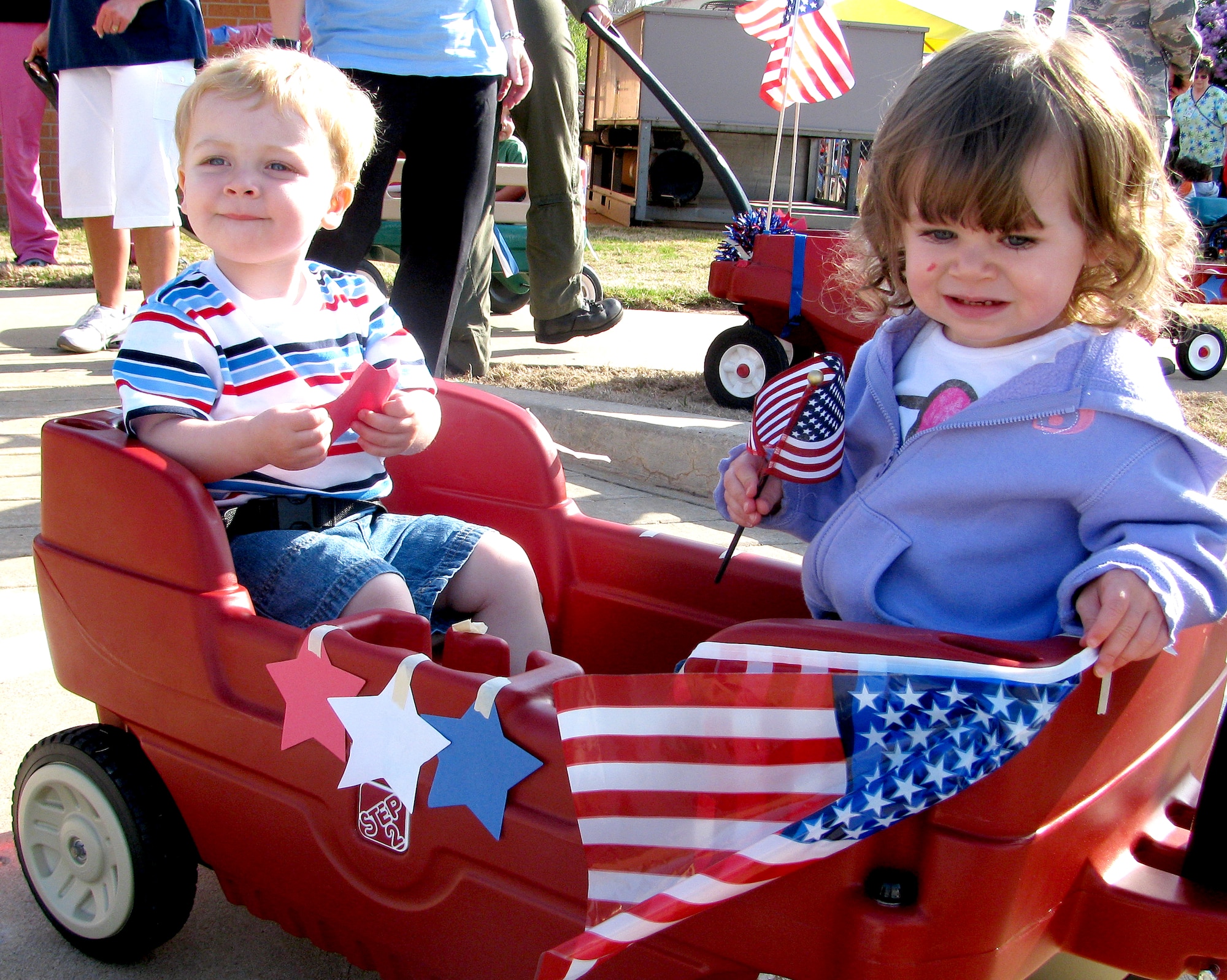 Brody Murphy, left, son of Capt. Mark Murphy with the 32nd Flying Training Squadron and Ashley Murphy with the 71st Force Support Squadron, and Payton Snyder, daughter of Staff Sgts. John and Amy Snyder, 71st Medical Group, ride in the military-child parade April 14, at Vance AFB, Okla. Brody and Payton are both in the pre-toddler classroom at the Vance Child Development Center. (U.S. Air Force photo/ Jillian Moore)