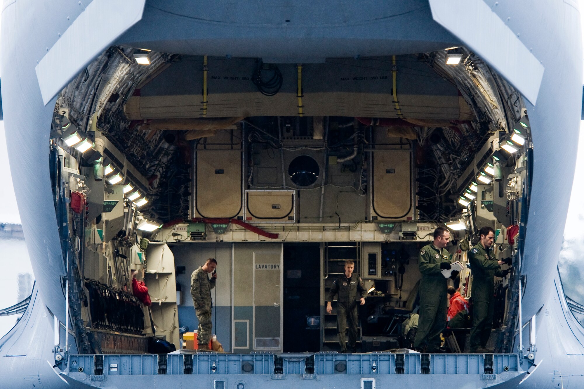 Staff Sgt. Joseph Cimino, 8th Airlift Squadron loadmaster, right, performs a pre-flight inspection onboard a C-17 Globemaster III in preparation for a heavy airdrop mission  April 13. Sergeant Cimino is one of more than 100 Airmen preparing for an upcoming deployment to the Middle East.   (U.S. Air Force Photo by Abner Guzman)