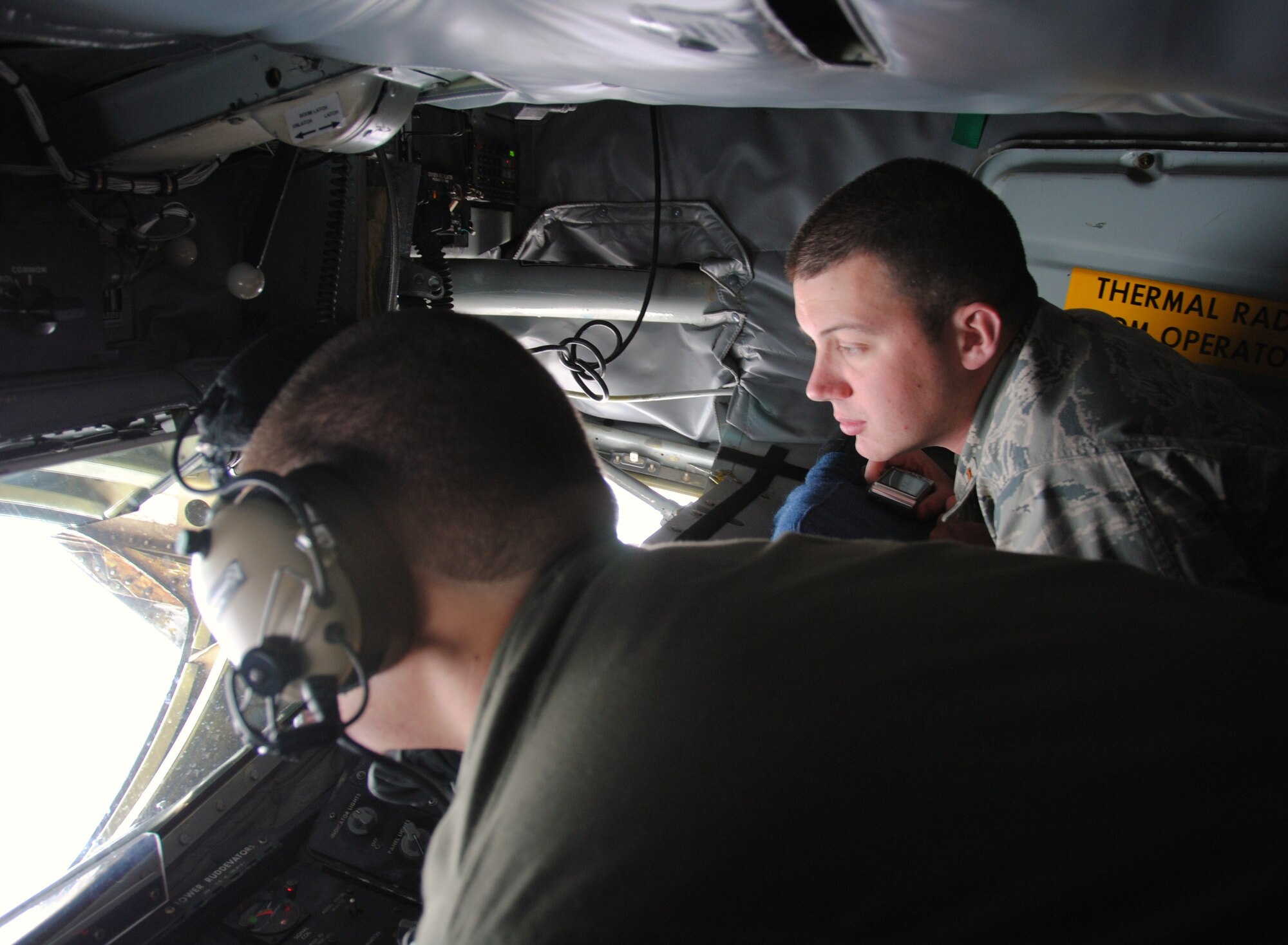 2nd Lt. Alex Burgess, a student awaiting pilot training, assigned to the 71st Operations Support Squadron at Vance AFB, observes the refueling of a B-1 Lancer April 6 by KC-135 boom operator, Senior Airman Mark Waski of the 22nd Air Refueling Wing, McConnell AFB, Kan. (U.S. Air Force photo/ 2nd Lt. Christopher Buzzetta)