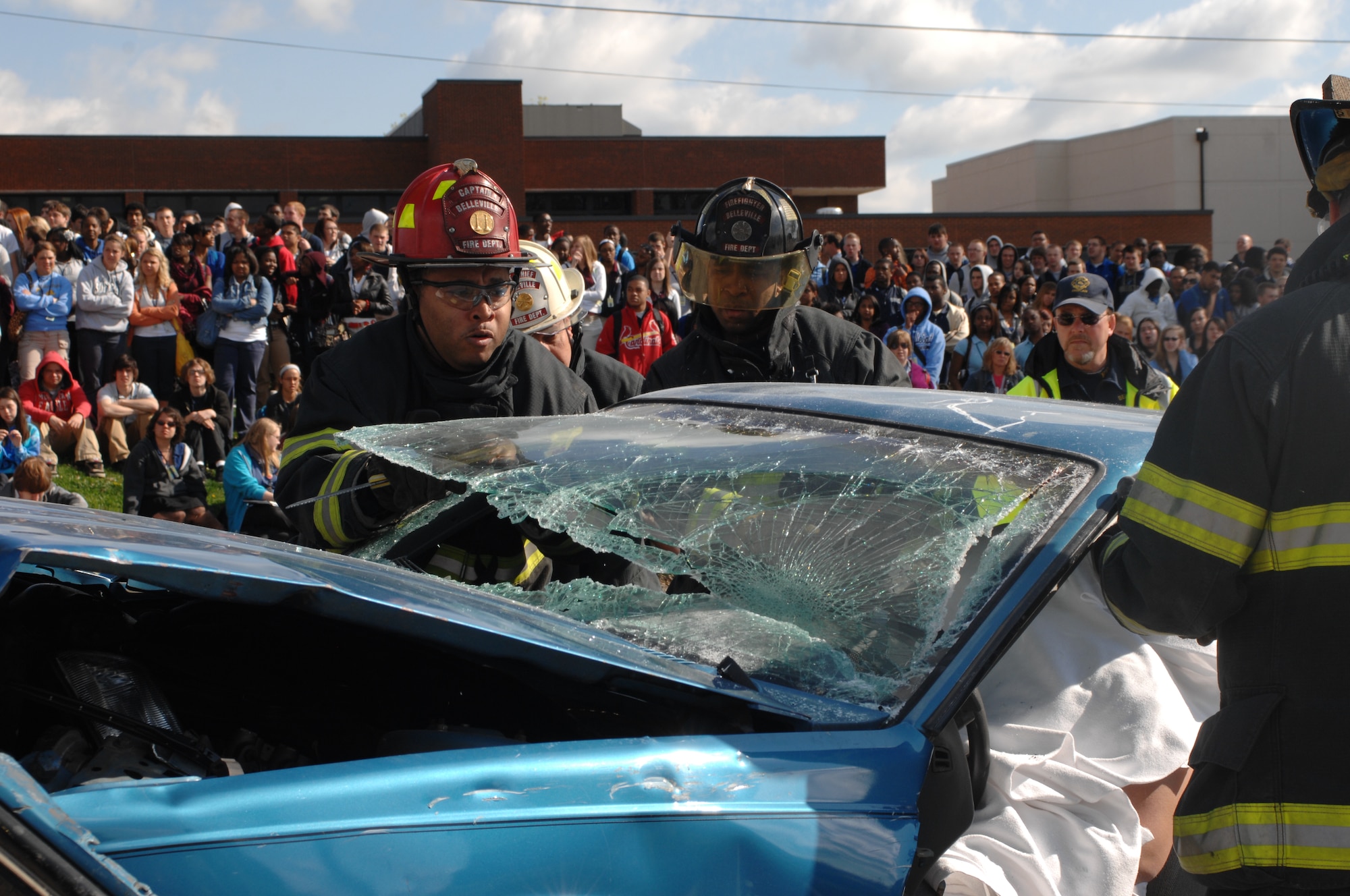 BELLEVILLE, Ill. -- Belleville Fire Department firefighters remove the glass from a vehicle involved in a simulated alcohol-related car accident before removing the top of the car to access one deceased and two critically injured victims. (U.S. Air Force Photo by Airman 1st Class Amber Kelly-Herard) 