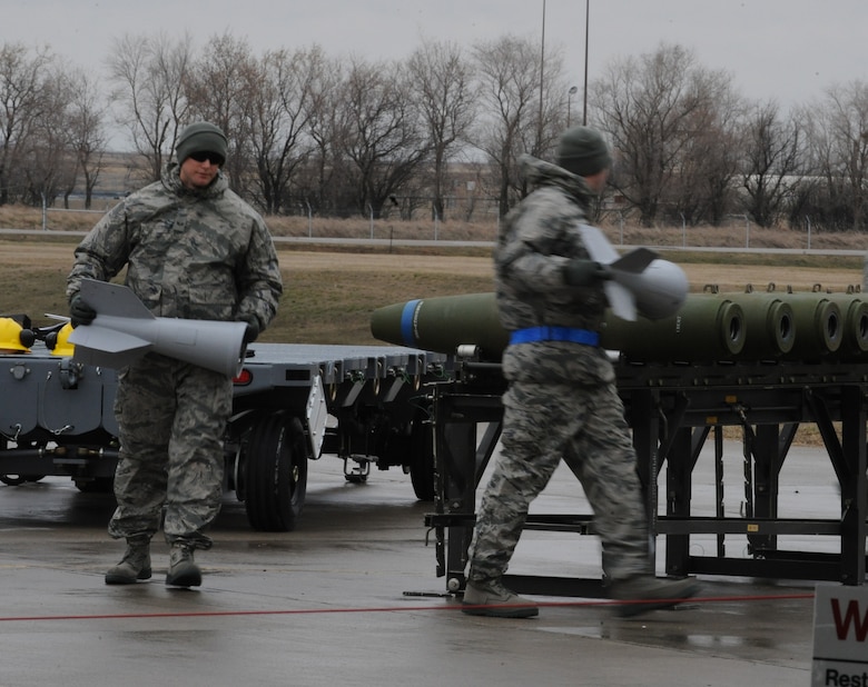 MINOT AIR FORCE BASE, N.D. -- Load crew members attach the fins to conventional bombs April 13 in a load crew competition here. The 5th Bomb Wing joined six other bomb wings in Air Force Global Strike Command’s first-ever load competition April 13 and 14 here. The evaluation was based not only on the Warbird’s hands-on skills, but also their knowledge in their respective career fields. (U.S. Air Force photo by Staff Sgt. Stacy Moless)
