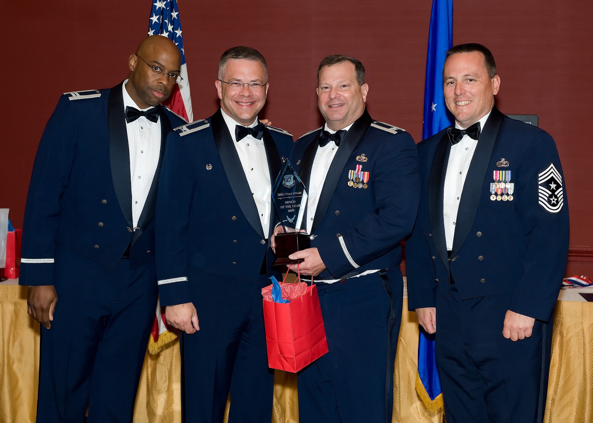 512th Maintenance Group Commander Col. Alan Lerner accepts the 2009 512th Airlift Wing Senior NCO of the Year award on behalf of Master Sgt. Vyjai Itwaru, 512th Maintenance Squadron, who was unable to attend the 512th AW Annual Awards Banquet April 10 at the Sheraton in Dover. (U.S. Air Force photo/Jason Minto) 