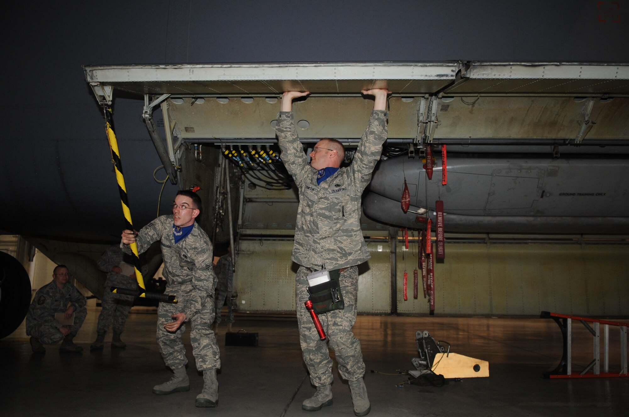 MINOT AIR FORCE BASE, N.D. -- Tech. Sgt. Brenton Sampson and Senior Airmen John Bumbalough, both 5th Aircraft Maintenance Squadron load crew members, participate in a load crew completion April 13 here. The 5th Bomb Wing joined six other bomb wings in Air Force Global Strike Command’s first-ever load competition April 13 and 14 here. The evaluation was based not only on the Warbird’s hands-on skills, but also their knowledge in their respective career fields. (U.S. Air Force photo by Staff Sgt. Stacy Moless)