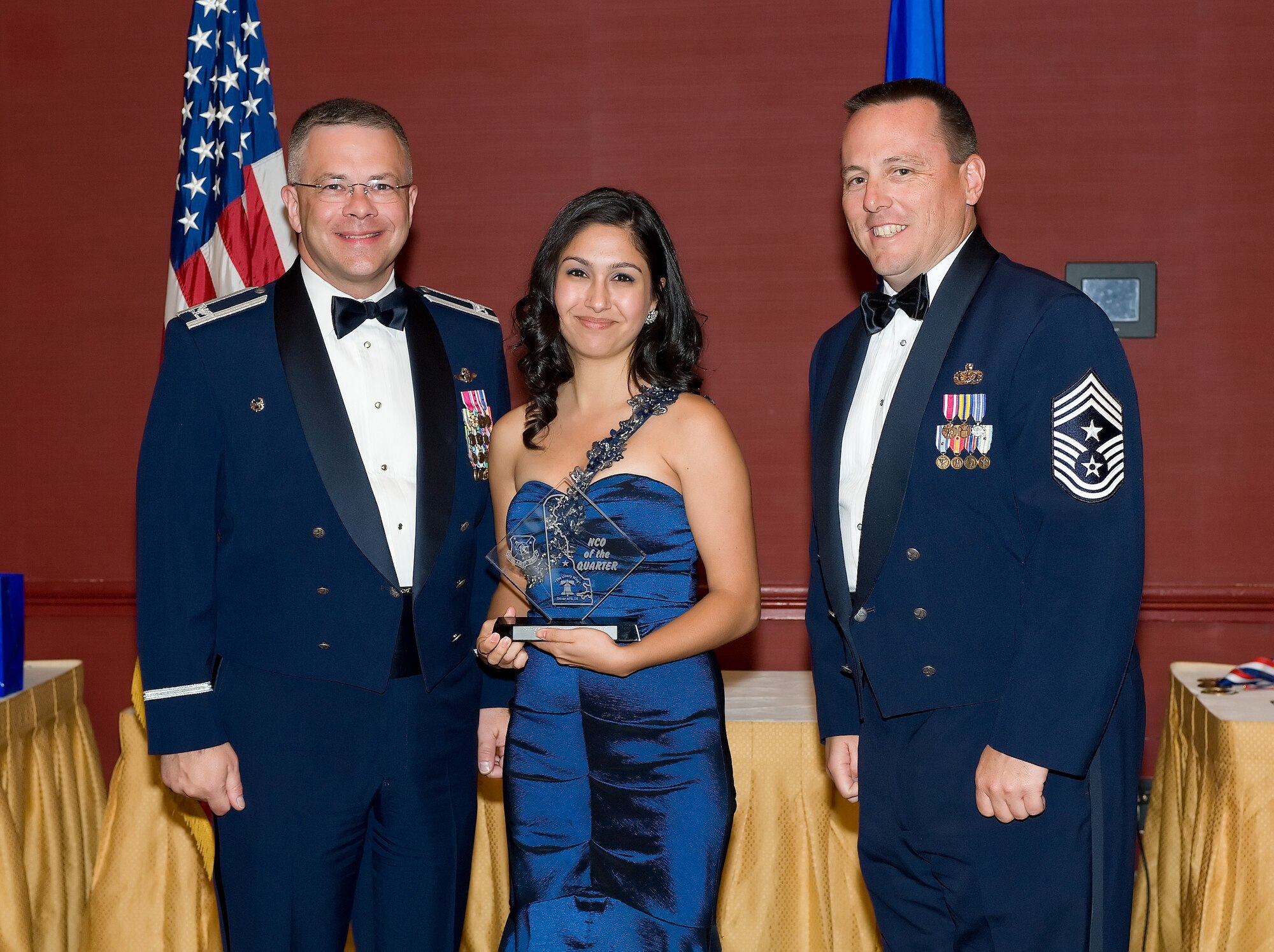Jade Spencer, wife of Staff Sgt. Michael Spencer, 512th Logistics Readiness Flight, accepts her spouse's award during the 512th AW Annual Awards Banquet April 10 at the Sheraton in Dover. Her husband is the 2009 512th Airlift Wing NCO of the second quarter and the 512th AW NCO of the Year. (U.S. Air Force photo/Jason Minto) 