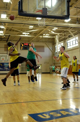 Players from the 628th Logistics Readiness Squadron and the 628th Comptroller Squadron leap for the ball during a playoff game at the Fitness and Sports Center April 13, 2010, at Joint Base Charleston, S.C. Sixteen teams started the playoffs April 13 and only one will remain come April 16.(U.S. Air Force Photo/Airman 1st Class Lauren Main)