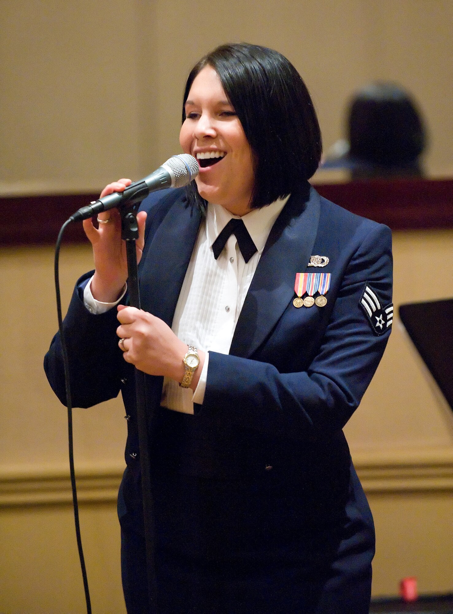 Senior Airman Amy Aguilera, vocalist for the Blue Aces of the U.S. Air Force Heritage of America Band, sings before an audience of 300 base members at the 512th Airlift Wing Annual Awards Banquet April 10 at the Sheraton in Dover. (U.S. Air Force photo/Jason Minto)