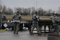 MINOT AIR FORCE BASE, N.D. -- Load crew members attach the fins to conventional bombs April 13 in a load crew competition here. The 5th Bomb Wing joined six other bomb wings in Air Force Global Strike Command’s first-ever load competition April 13 and 14 here. The evaluation was based not only on the Warbird’s hands-on skills, but also their knowledge in their respective career fields. (U.S. Air Force photo by Staff Sgt. Stacy Moless)