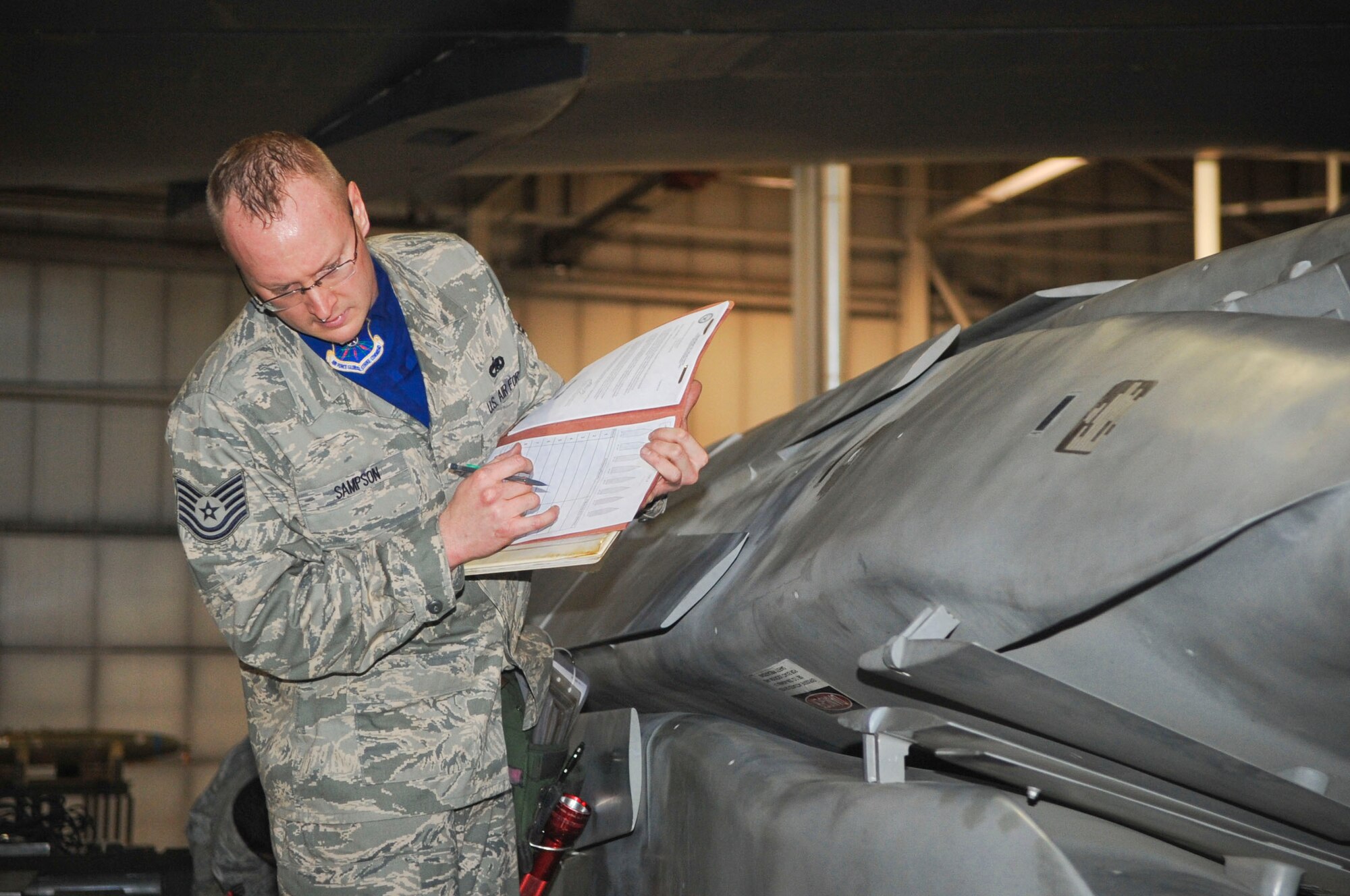 MINOT AIR FORCE BASE, N.D. -- Tech. Sgt. Brenton Sampson, 5th Aircraft Maintenance Squadron load crew member, participates in a load crew competition April 13 here. The 5th Bomb Wing joined six other bomb wings in Air Force Global Strike Command’s first-ever load competition April 13 and 14 here. The evaluation was based not only on the Warbird’s hands-on skills, but also their knowledge in their respective career fields. (U.S. Air Force photo by Staff Sgt. Stacy Moless)