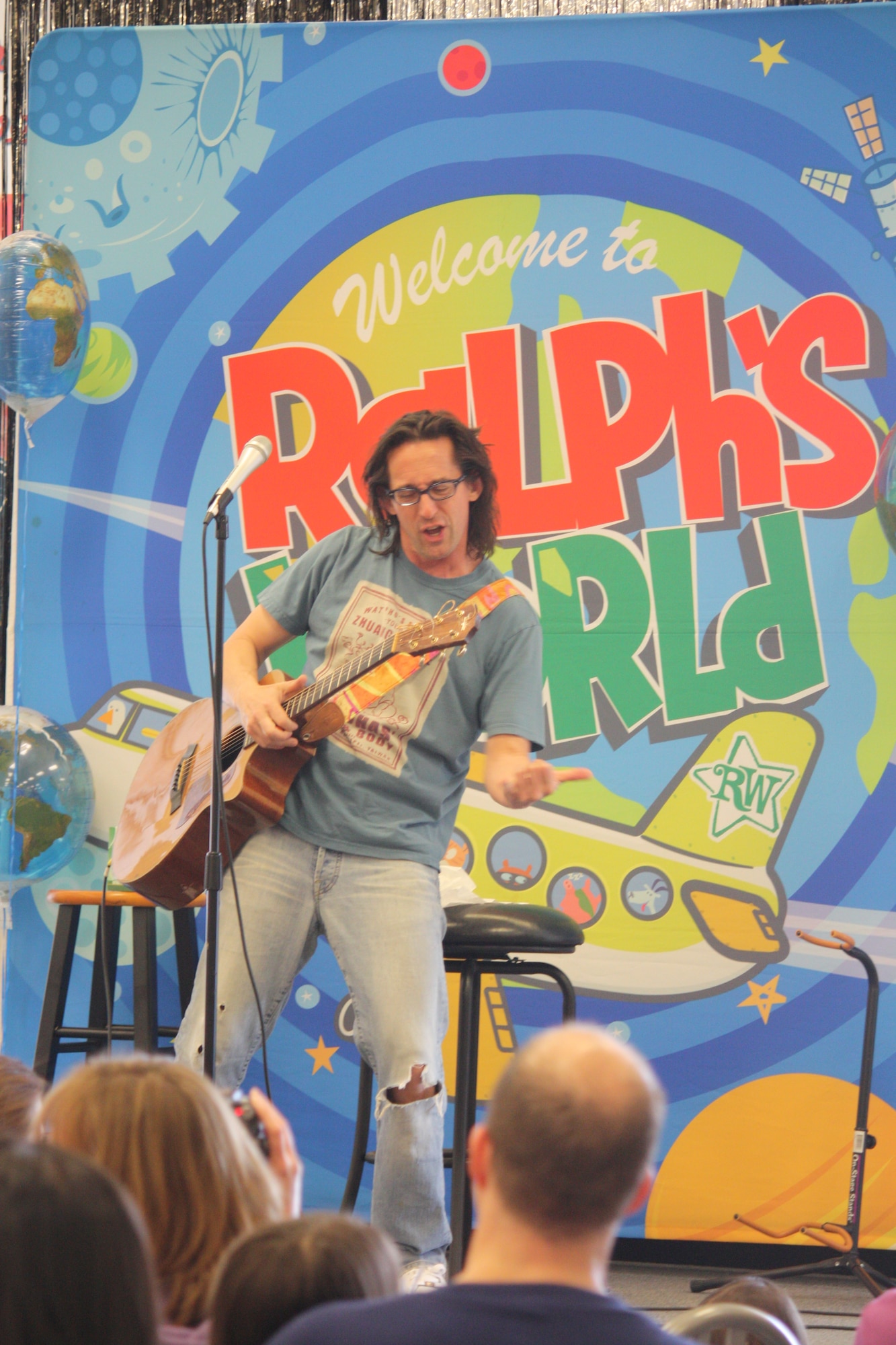SCOTT AIR FORCE BASE, Ill. -- Ralph Covert, of “Ralph’s World,” performs Saturday at Scott’s Base Exchange.  After the performance and meet-and-greet, Ralph toured the base. Courtesy Photo