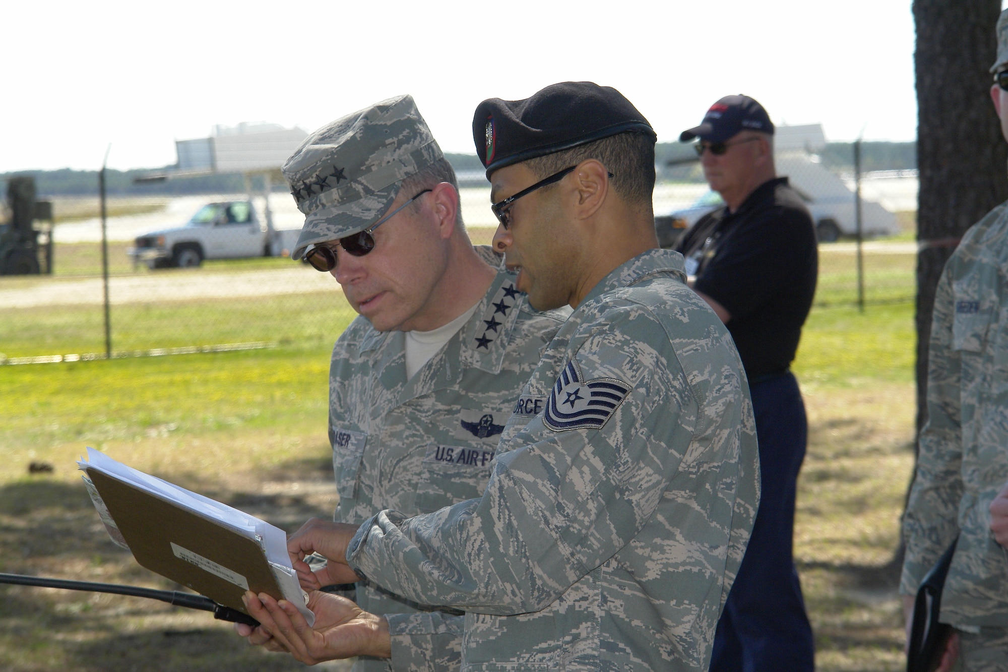 Gen. William Fraser, Commander of the Air Combat Command, and Tech. Sgt. Jeff Porter, 14th Air Support Operations Squadron, review and discuss the Airborne Assault Demonstration on the Pope flightline March 31. The demonstration included members from the 14th ASOS and the 18th Weather Squadron. (U.S. Air Force Photo by Mike Murchison) 