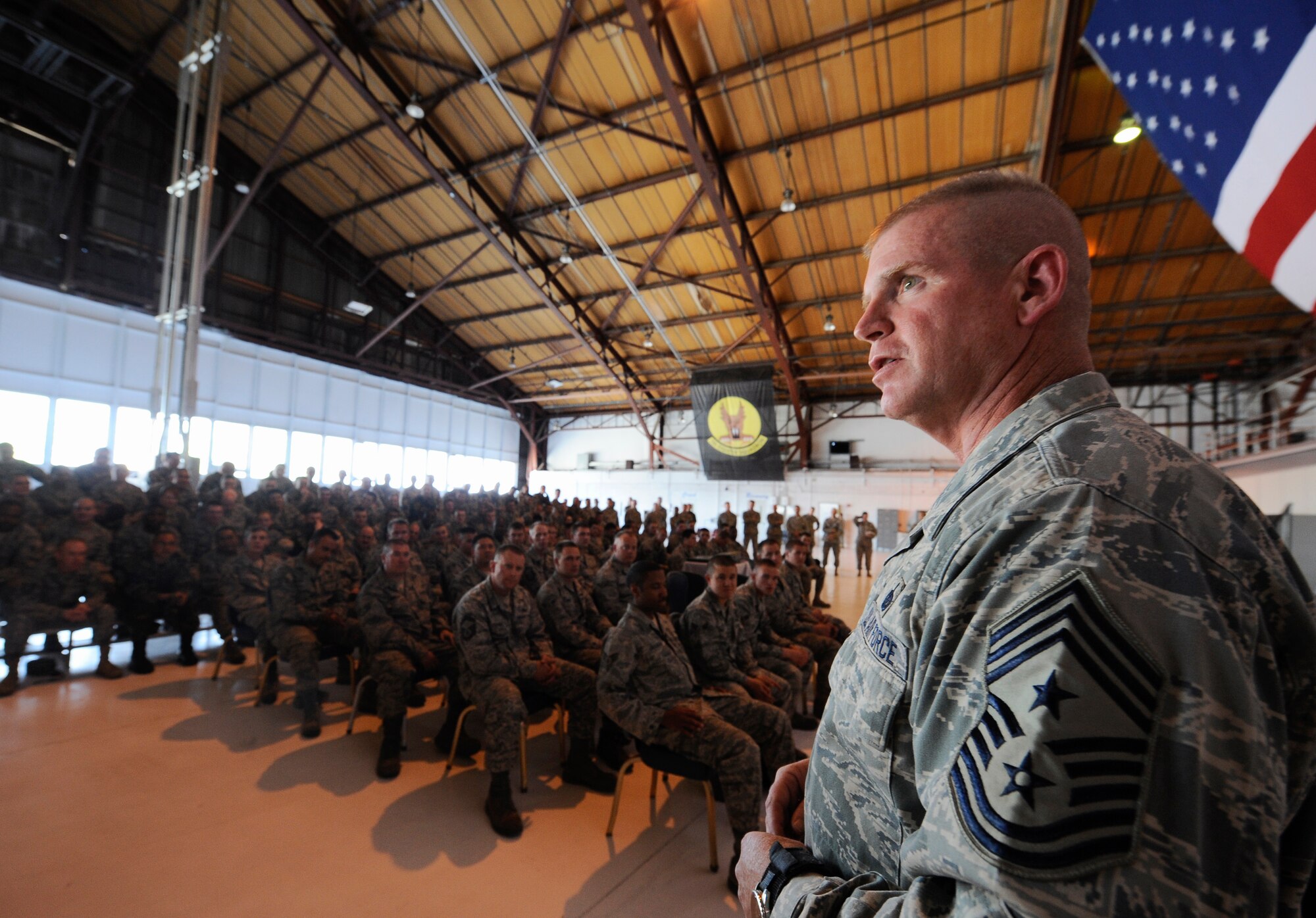 HOLLOMAN AIR FORCE BASE, N.M. -- Chief Master Sgt. Harold Clark, 12th Air Force command chief, speaks to Airmen at the 49th Maintenance Group All Call at Hangar 877, April 6, 2010. Airmen from the 49th MXG listen as Chief Clark discusses how every Airmen contributes to the Air Force mission through teamwork. (U.S. Air Force photo by Airman 1st Class Veronica Stamps / Released)
