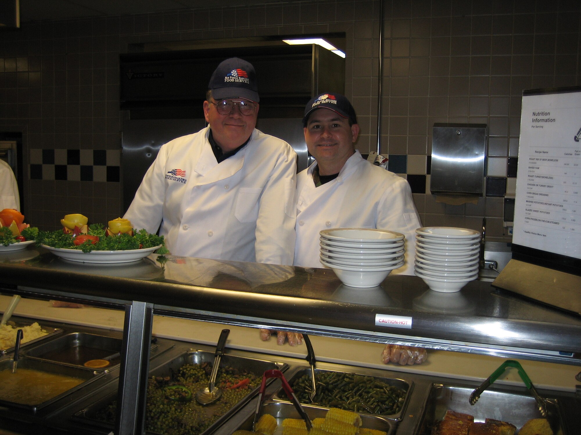 DOVER AIR FORCE BASE, Del. -- Colonel Webb behind the serving line at the Dover Dining Facility with Mr. Joe Yacyshyn, a Dover Honorary Squadron Commander, serving Thanksgiving dinner to junior enlisted troops in 2005. Courtesy photo