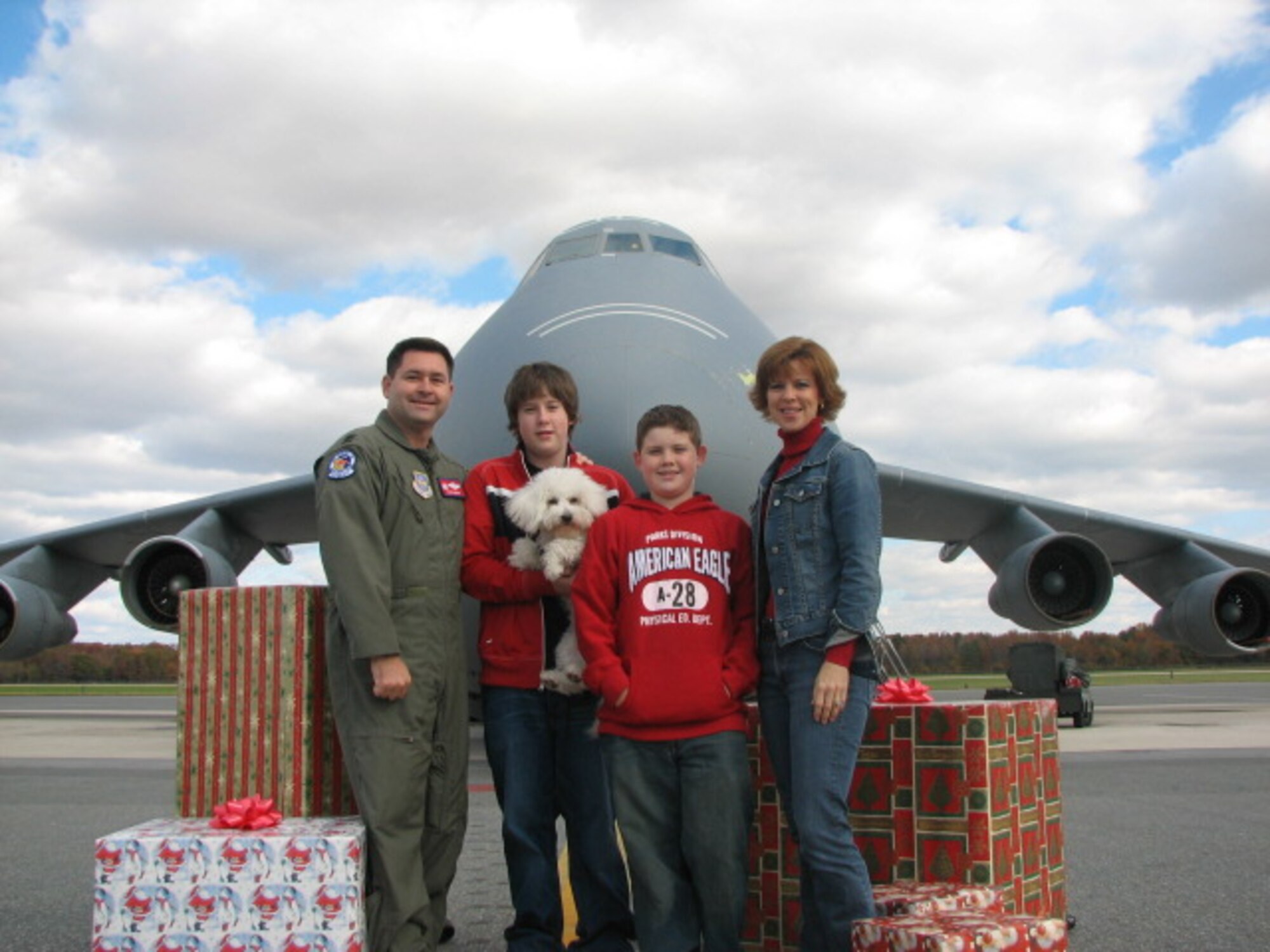 DOVER AIR FORCE BASE, Del. -- Col. Kevin Webb, 375th Air Mobility Wing vice commander, his sons Michael and Dock, and his wife, Sandra, pose for a Christmas photo in front of a C-5 Galaxy at Dover Air Force Base, Del., in 2005.  Colonel Webb, then the squadron commander of Dover’s 3rd Airlift Squadron, arranged to have family photos taken in front of the aircraft leading up to their squadron holiday party, many photos were taken and sent to the deployed members. Courtesy photo