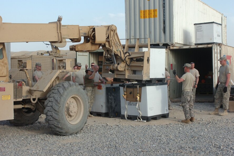 Members of the Arkansas ADT unload their supplies and equipment from shipping containers at Forward Operating Base Apache in southern Afghanistan. The ADT reached its base camp at Apache on April 5, 2010, and has been busily setting up its housing tents, organizing supplies and equipment and preparing to begin work. (Photo by Lt. Col. Keith Moore/Arkansas ADT Public Affairs officer)