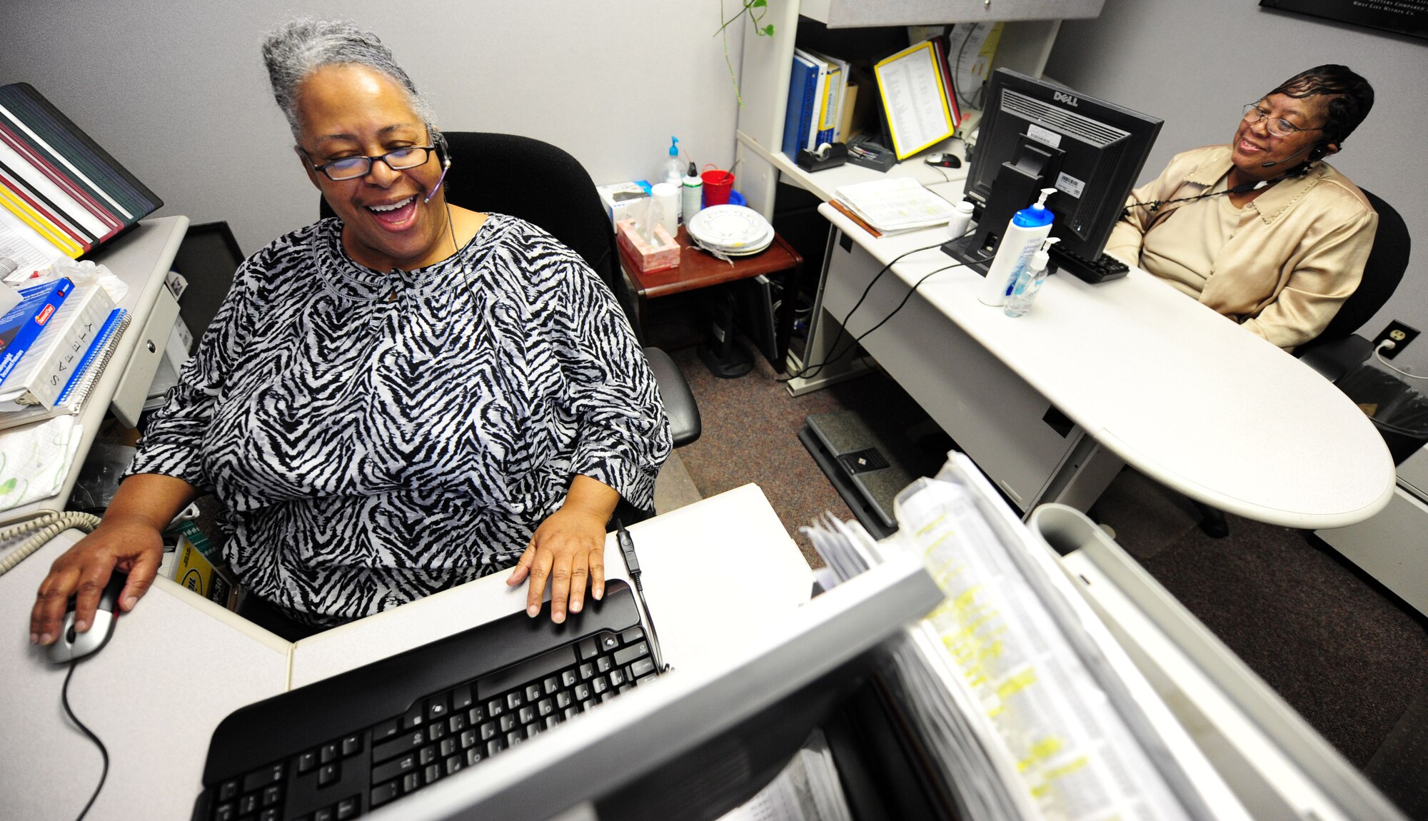 (Left to right) Lavernia Johnson and Gail Munn, 19th Communications Squadron base operators, answer phone calls April 14 on their final duty day on base. Mrs. Johnson and Mrs. Munn both served as telephone operators at Little Rock Air Force Base for more than 28 years. Phone calls to 987-1110 will now be handled at Travis Air Force Base, Calif., under a new operator system. (U.S. Air Force photo by Senior Airman Steele C. G. Britton)