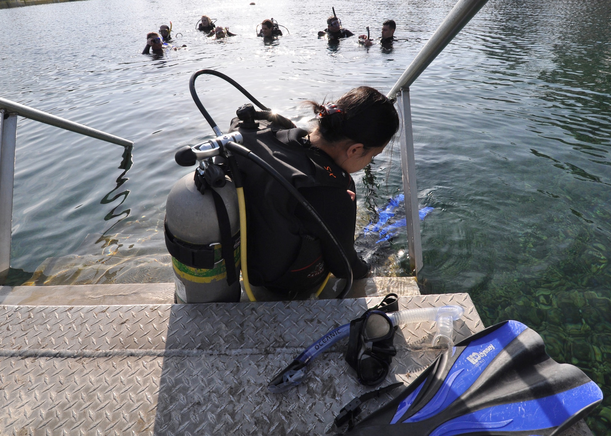 Angela Sangalang, a divemaster in training, puts on her fins before joining the group for their first deep-water dive during Day 3 of the certification course taught here at Eglin.  The class is four days over two weekends and it occurs once a month.  After taking the course, students will be certified to dive in up to 60 feet of water.  Anyone interested in attending the class, can call 850-217-1261.  (U.S. Air Force photo/Samuel King Jr.)
