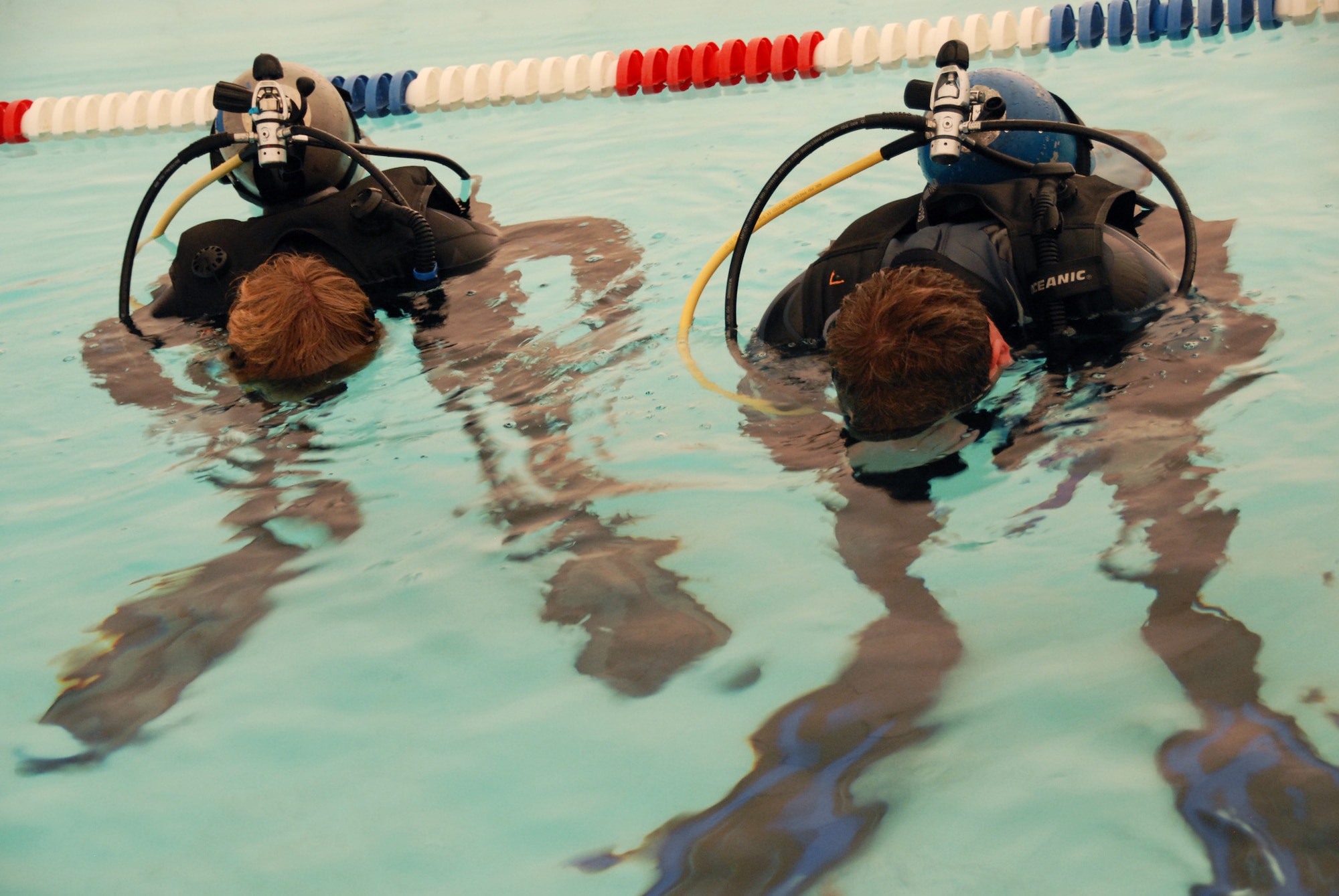 (Left to right) Mark and his father Ken Sharp, 681st Armament Systems Squadron, practice using the scuba gear underwater during Day 2 of the certification course taught here at Eglin.  The class is four days over two weekends and it occurs once a month.  After taking the course, students will be certified to dive in up to 60 feet of water.  Anyone interested in attending the class, can call 850-217-1261.  (U.S. Air Force photo/Samuel King Jr.)