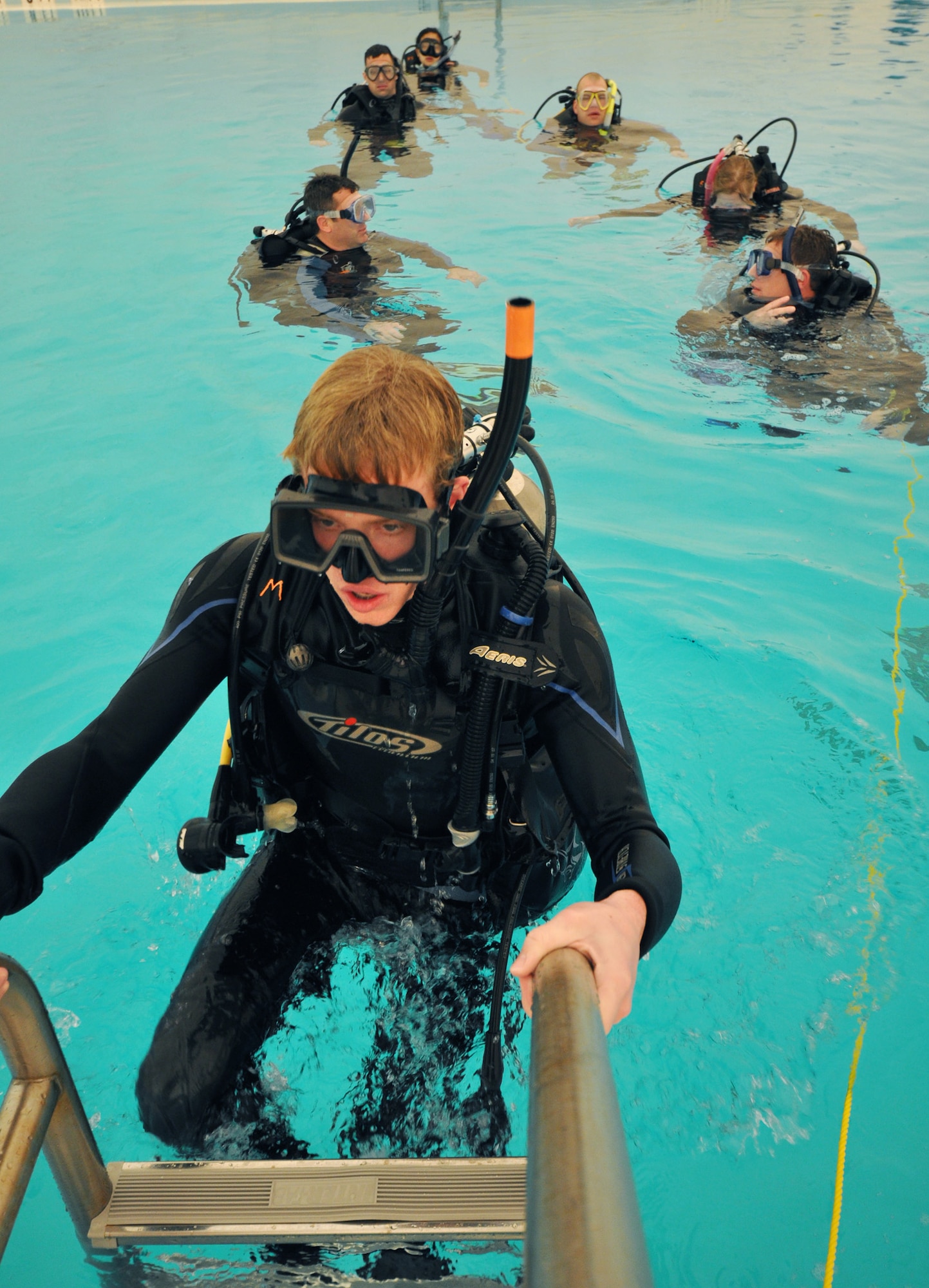 Mark Sharp, daughter of Ken Sharp, 681st Armament Systems Squadron, leads the class out of the pool at the end of Day 2 of the certification course taught here at Eglin.  The class is four days over two weekends and it occurs once a month.  After taking the course, students will be certified to dive in up to 60 feet of water.  Anyone interested in attending the class, can call 850-217-1261.  (U.S. Air Force photo/Samuel King Jr.)