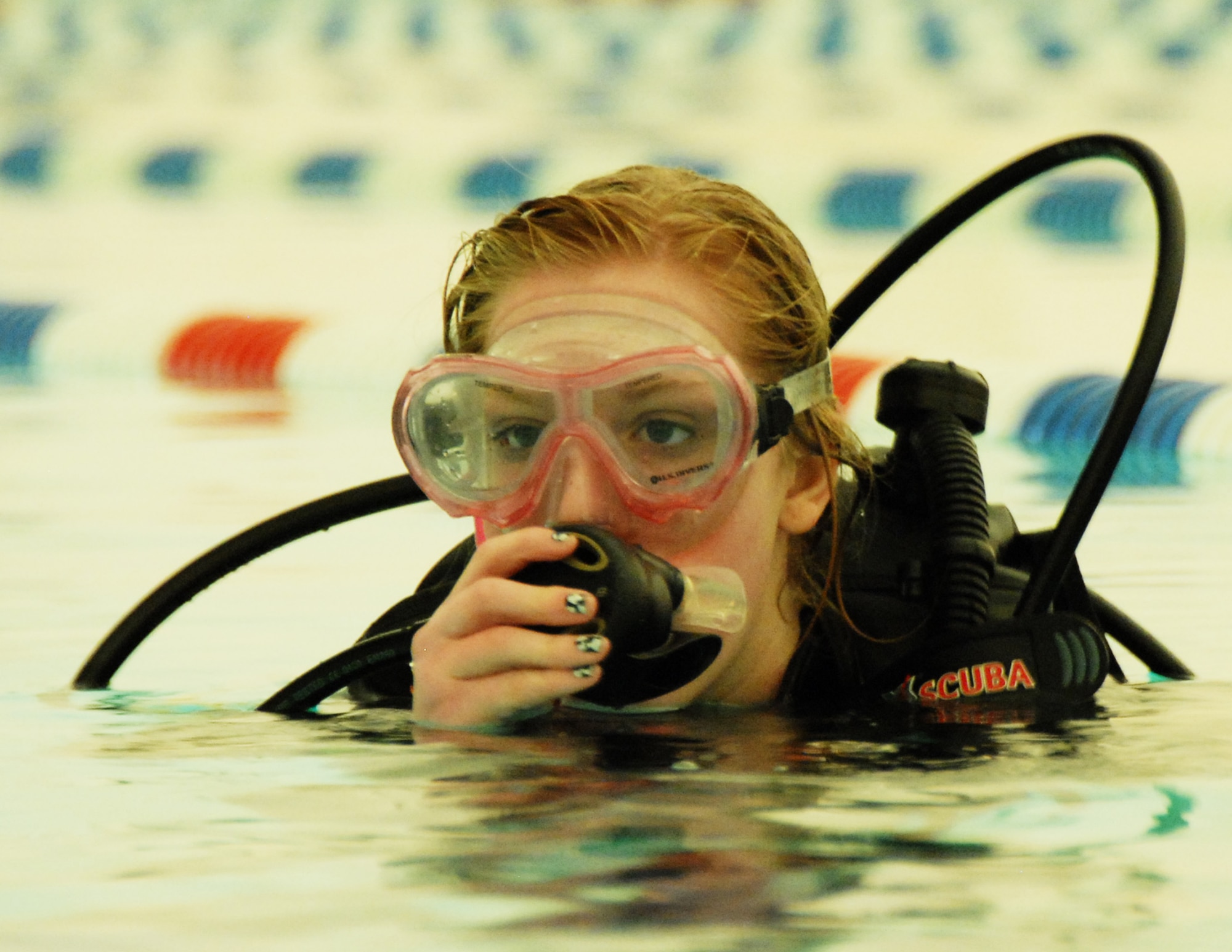 Melissa Sharp, daughter of Ken Sharp, 681st Armament Systems Squadron, tests her breathing apparatus during Day 2 of the certification course taught here at Eglin.  The class is four days over two weekends and it occurs once a month.  After taking the course, students will be certified to dive in up to 60 feet of water.  Anyone interested in attending the class, can call 850-217-1261.  (U.S. Air Force photo/Samuel King Jr.)