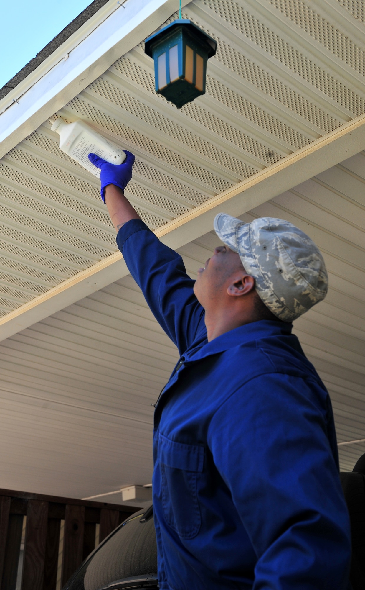 100412-F-8430J-045
SHAW AIR FORCE BASE, S.C. - Senior Airman Terrence Murray, 20th Civil Engineer Squadron entomologist, squeezes Delta Dust under the eaves of a home on base April 12, 2010. The Delta Dust is used to eliminate any possible bee hives or nests. The 20th CES entomologists specialize in pest control, eliminating weeds, and conducting health inspections. The 20th CES entomologists are vital to the Air Force since they are in charge of diseases and pest control so troops and families can stay healthy.  (U.S. Air Force photo/Airman 1st Class Amber E. N. Jacobs)