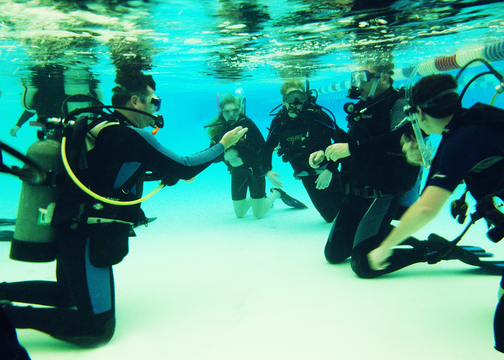 Robert Hyde, (left) instructor for the Dive Flight’s certification course, goes over signals underwater during Day 2 of the course at Eglin.  The class is four days over two weekends and it occurs once a month.  After taking the course, students will be certified to dive in up to 60 feet of water.  Anyone interested in attending the class, can call 850-217-1261.  (U.S. Air Force photo/Samuel King Jr.)