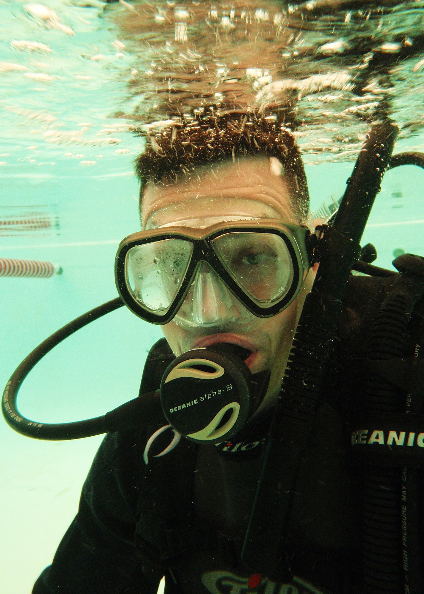 1st Lt. Brian Wernle, 366th Training Squadron, ducks underwater while learning to breathe with the scuba gear during Day 2 of the certification course taught here at Eglin.  The class is four days over two weekends and it occurs once a month.  After taking the course, students will be certified to dive in up to 60 feet of water.  Anyone interested in attending the class, can call 850-217-1261.   (U.S. Air Force photo/Samuel King Jr.)