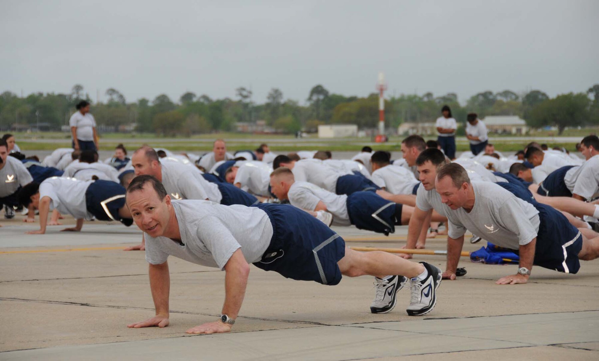 Lt. Col. Ray Adams, 81st Training Group commander, does pushups before the 81st Training Wing's quarterly flightline run April 7.  (U.S. Air Force photo by Kemberly Groue)