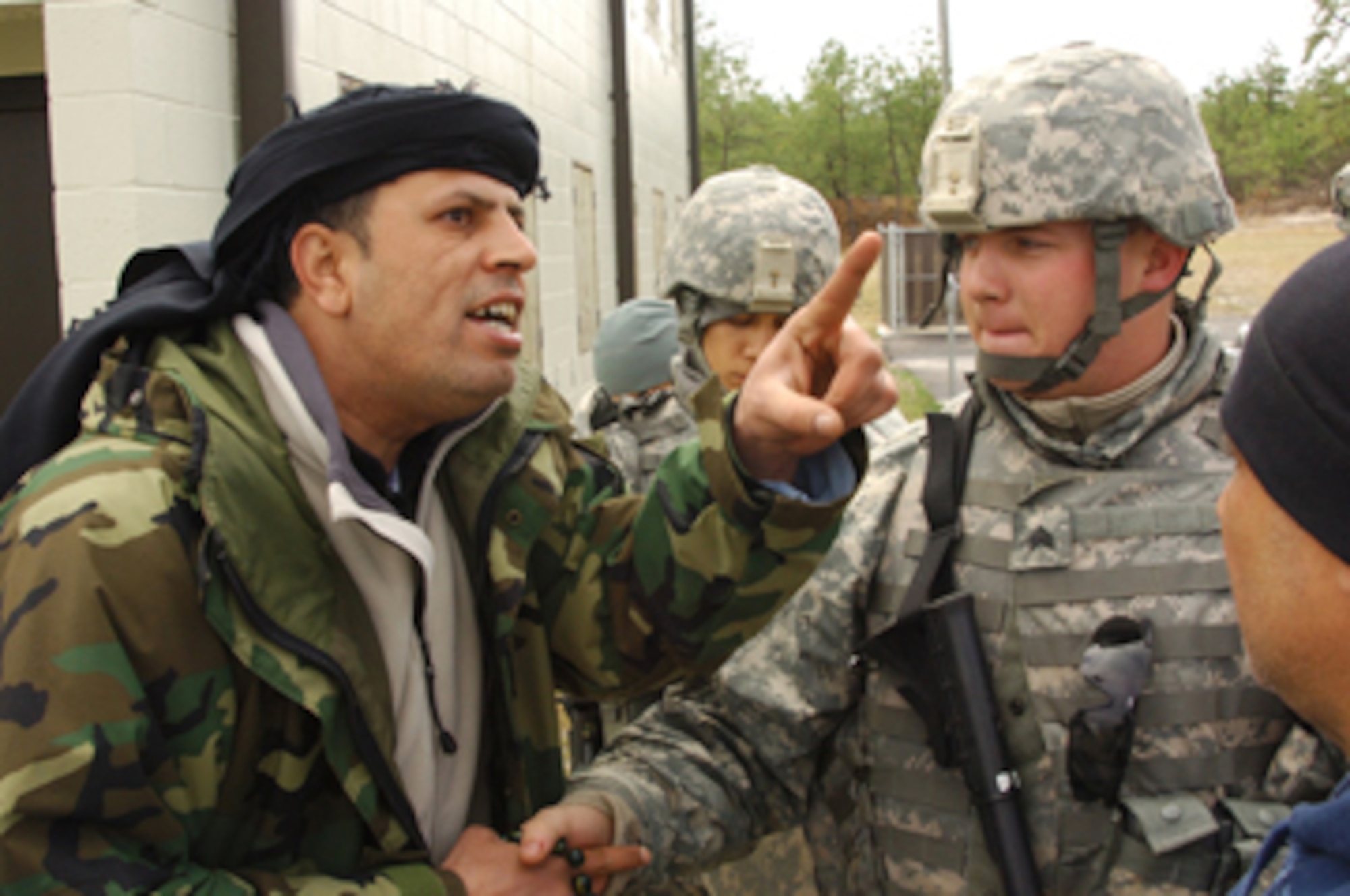Cpl. Nathan Swanson, shakes the hand of a role play actor called a civilian on the battlefield during a training exercise at Joint Base McGuire-Dix-Lakehurst March 31. Swanson is a member of the Army Reserve's 17th Psychological Operations Battalion, from Houston, Texas, and he and his fellow Soldiers are currently JB MDL training for upcoming deployments to Iraq and Afghanistan. (U.S. Army photo/Ryan Morton)
