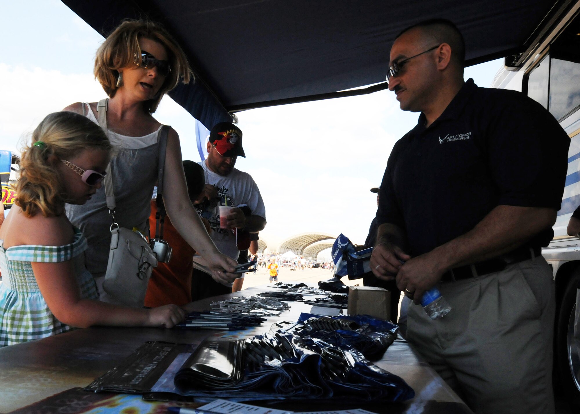 Possible recruits stop by and pick up "goodies" at the Air Force Reserve tent April 11 at the Eglin Air Force Base 75th Anniversary Airshow.  More than 125,000 were in attendance during the air show April 10-11, enjoying a variety of aerial performances and static displays. This was Eglin’s first open house since 2007 and was timed to coincide with the 75th anniversary of the installation. The Thunderbirds, F-22A Raptor demo and “Tora, Tora, Tora” were some of the highlights of the event.  (U.S. Air Force photo/Tech. Sgt. Samuel King Jr.)