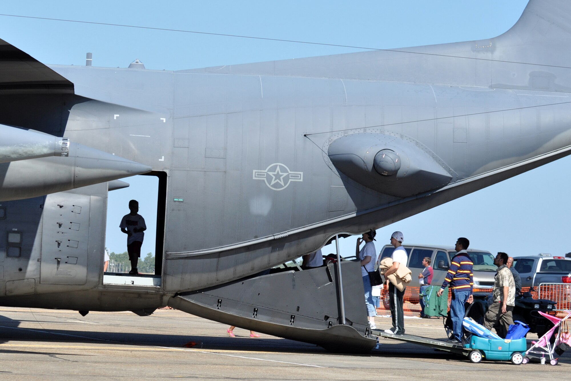 A young airshow patron stands in the door way of a 919th Special Operations Wing  C-130E Combat Talon while others wait to climb in for a tour of the aircraft April 11 at the Eglin Air Force Base 75th Anniversary Airshow.  More than 125,000 were in attendance during the air show April 10-11, enjoying a variety of aerial performances and static displays. This was Eglin’s first open house since 2007 and was timed to coincide with the 75th anniversary of the installation. The Thunderbirds, F-22A Raptor demo and “Tora, Tora, Tora” were some of the highlights of the event.  (U.S. Air Force photo/Airman 1st Class Anthony Jennings.)