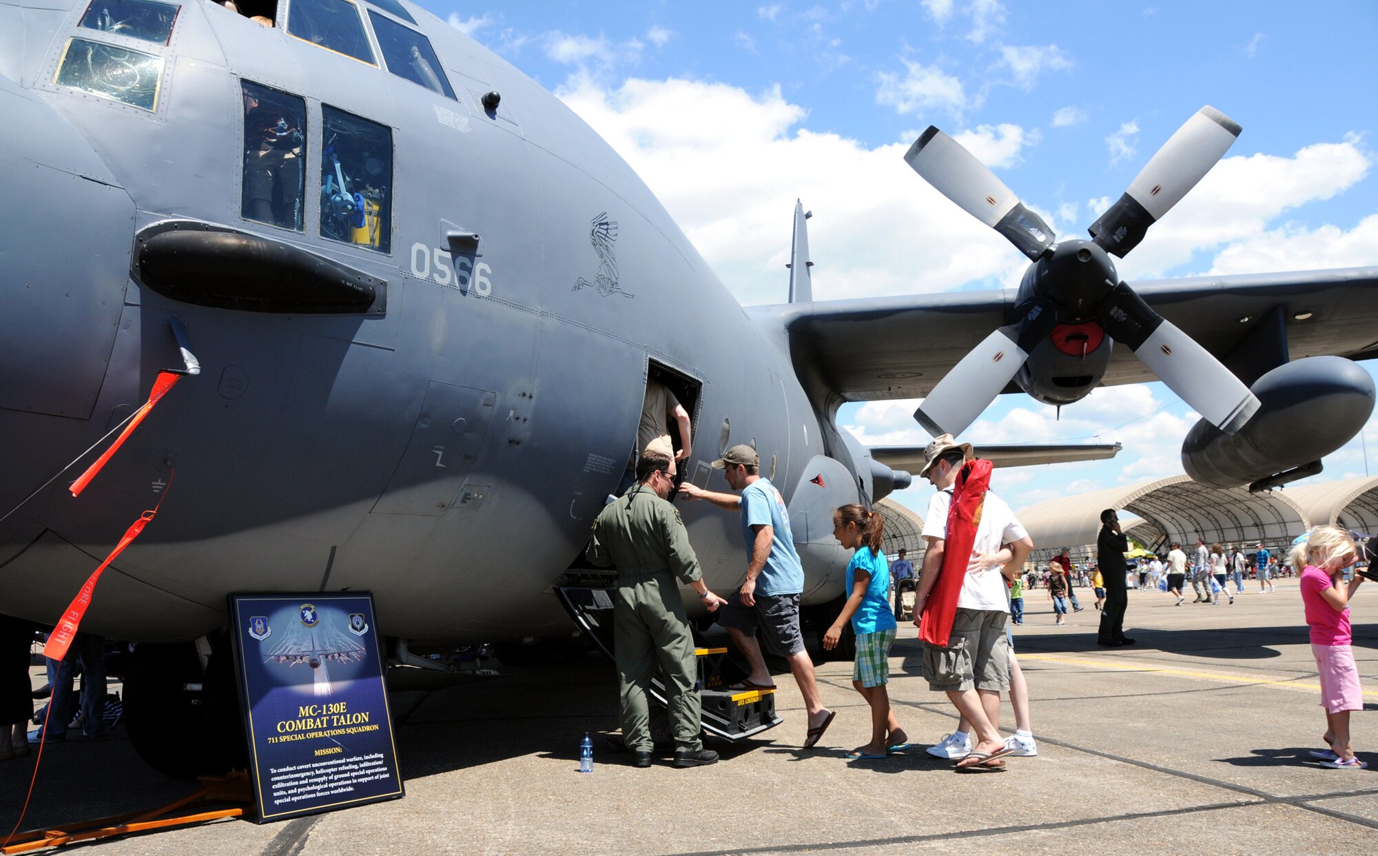 A 919th Special Operations Wing aircrew member helps patrons into a C-130E Combat Talon for a tour of the aircraft April 11 at the Eglin Air Force Base 75th Anniversary Airshow.  More than 125,000 were in attendance during the air show April 10-11, enjoying a variety of aerial performances and static displays. This was Eglin’s first open house since 2007 and was timed to coincide with the 75th anniversary of the installation. The Thunderbirds, F-22A Raptor demo and “Tora, Tora, Tora” were some of the highlights of the event.  (U.S. Air Force photo/Airman 1st Class Anthony Jennings.)