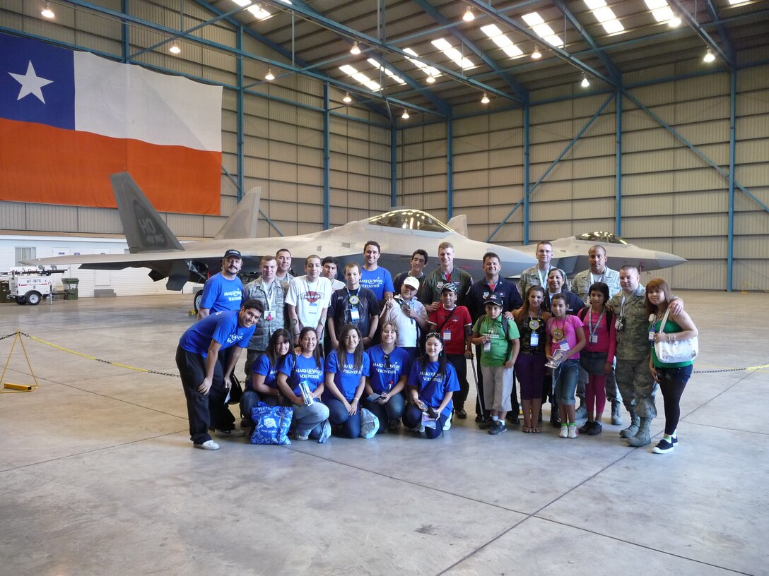 SANTIAGO, Chile -- Children from the Make a Wish Foundation, a charitable organization dedicated to assisting disabled and ill children around the world by creating once-in-a-lifetime memories, pose with members of Air Combat Command's F-22 Demonstration Team during the FIDAE air and trade show in Santiago, Chile.  The group toured Air Force displays, sat in the cockpit of cargo aircraft and met with Airmen for several hours during the international event.  Airmen were so moved by their interaction with the young VIPs, at the conclusion of the show, the Air Force delegation made a personal donation to the Make a Wish program.