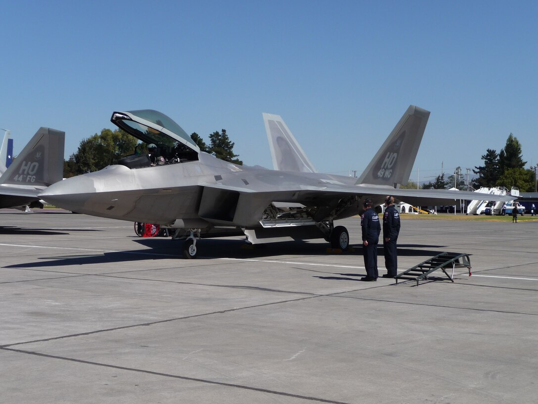 SANTIAGO, Chile -- Air Combat Command's F-22 Raptor Demonstration Team prepare for a flight during the FIDAE air and trade show in Santiago, Chile March 25th.  The Raptor Demonstration Team flew throughout the international event and also met with local community leaders, hosted children from various charitable organizations and visited a hospital for ill children. Airmen were so moved by their interaction with the Chilean children, at the conclusion of the show, the Air Force delegation made a personal donation to the Make a Wish program.