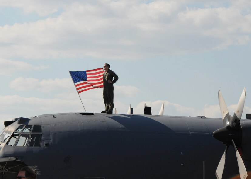 A 919th Special Operations Wing aircrew member watches the show from atop a C-130E Combat Talon April 11 at the Eglin Air Force Base 75th Anniversary Airshow.  More than 125,000 were in attendance during the air show April 10-11, enjoying a variety of aerial performances and static displays. This was Eglin’s first open house since 2007 and was timed to coincide with the 75th anniversary of the installation. The Thunderbirds, F-22A Raptor demo and “Tora, Tora, Tora” were some of the highlights of the event.  (U.S. Air Force photo/Tech. Sgt. Cheryl Foster.)